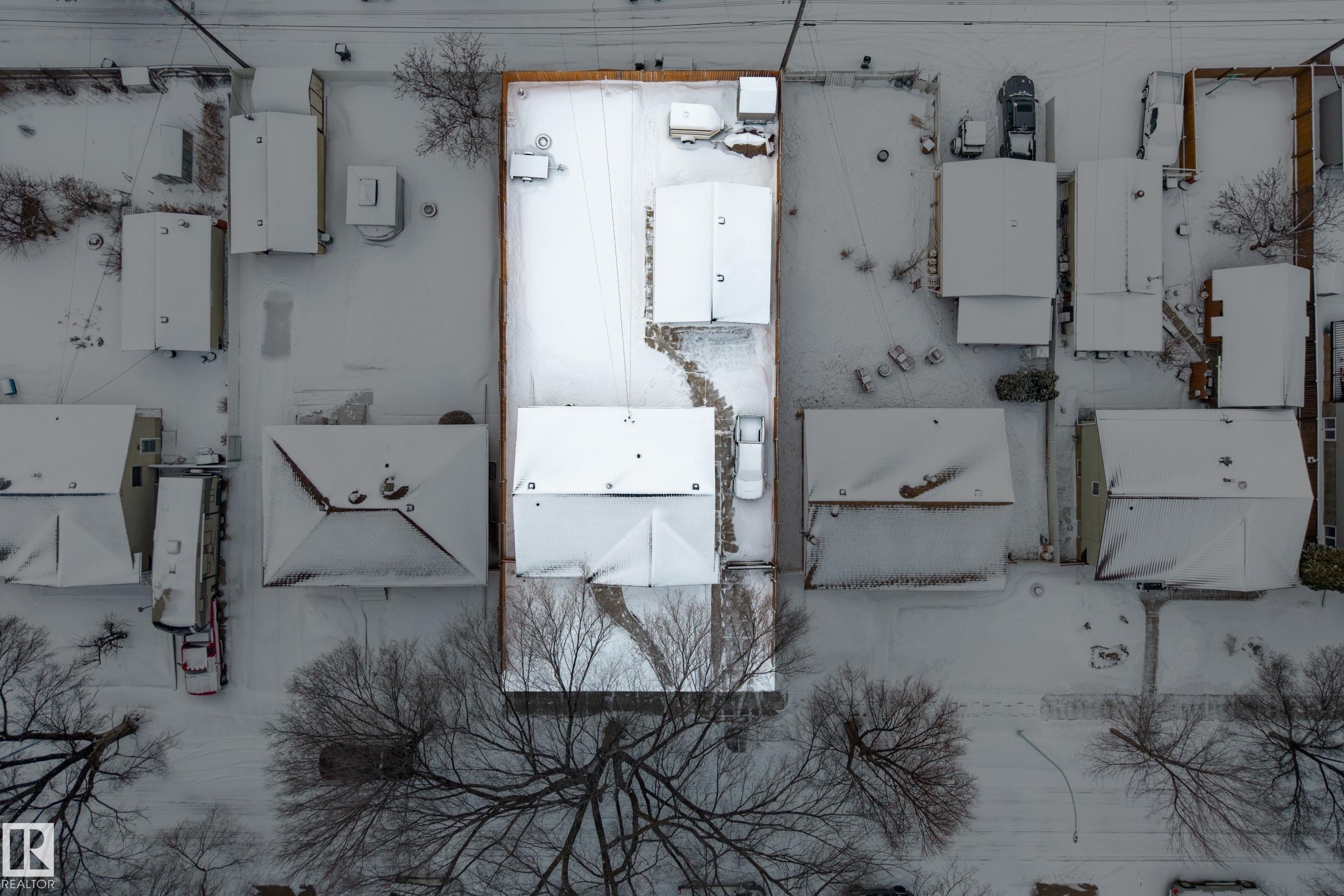 Aerial view of the property and surrounding neighborhood, featuring snow-covered rooftops and bare trees - 3613 113 Avenue, Edmonton, AB -