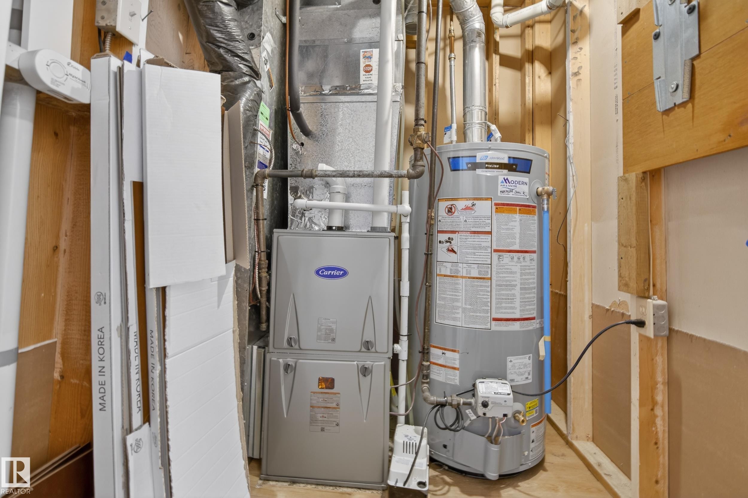 The property includes a water heater and a Carrier brand HVAC system - 3613 113 Avenue, Edmonton, AB - Indoor Photo Showing Basement