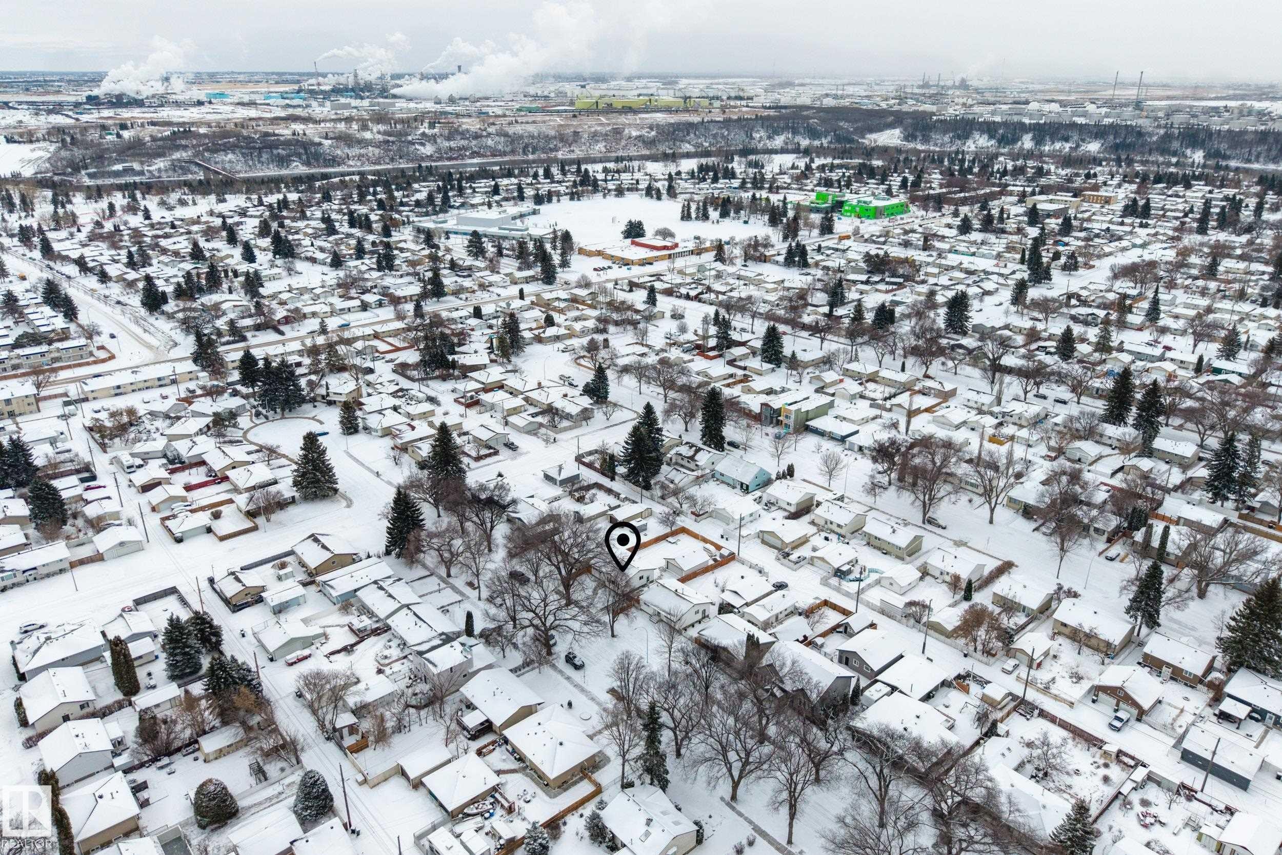 Aerial view of the surrounding neighborhood, featuring numerous residential properties with snow-covered rooftops and mature trees - 3613 113 Avenue, Edmonton, AB - Outdoor With View
