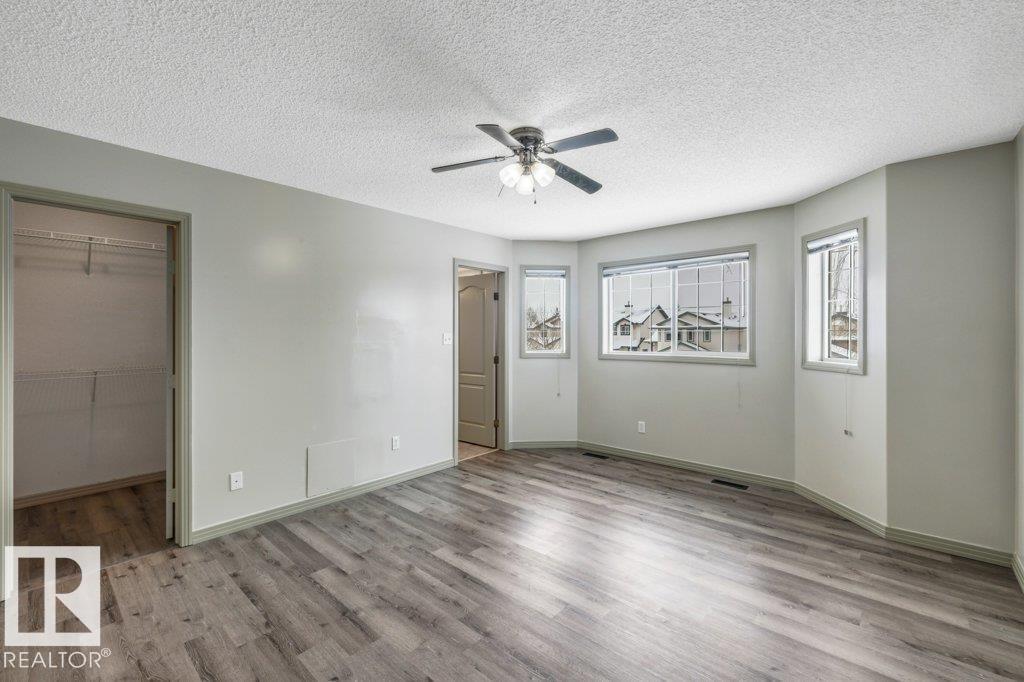This room features light grey walls and wood-style flooring - 902 Graham Wynd, Edmonton, AB - Indoor Photo Showing Other Room