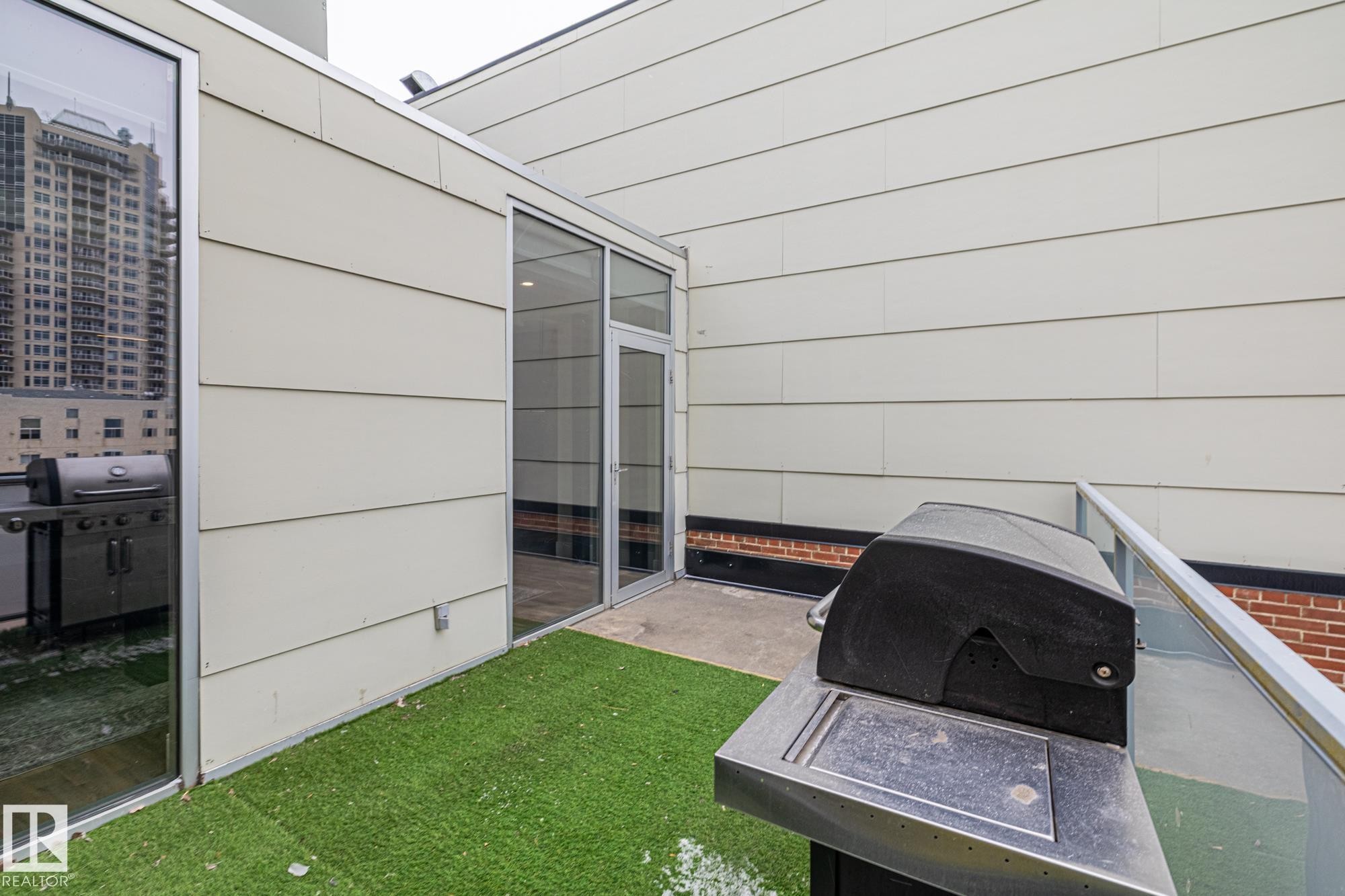 This property features an outdoor patio area with artificial turf flooring - 314 10309 107 Street, Edmonton, AB - Outdoor With Exterior