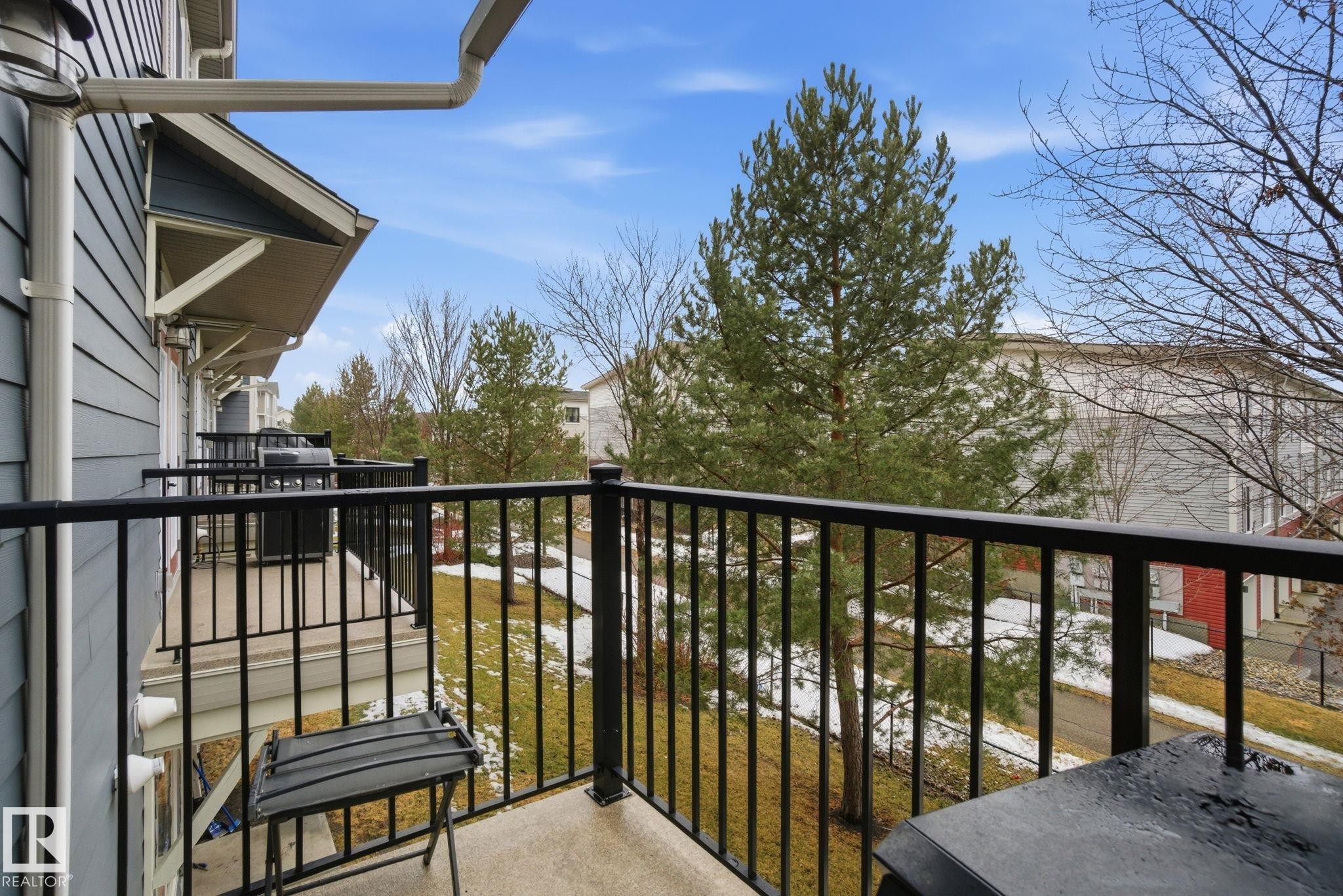 The property features a balcony with black railings and a concrete floor - 75 603 Watt Boulevard, Edmonton, AB - Outdoor With Balcony With Exterior