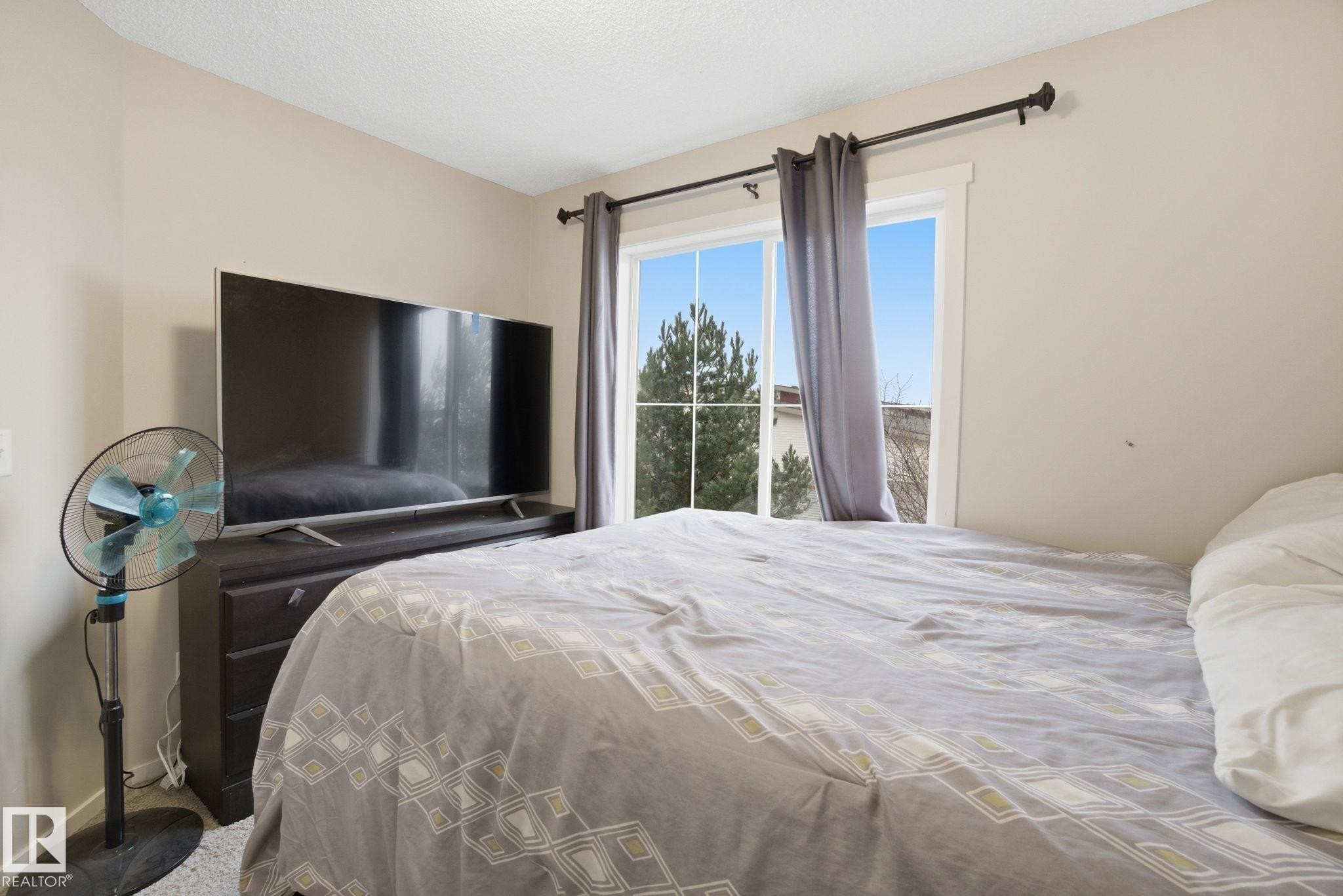 This room features a window with a view of greenery, complemented by light-colored walls - 75 603 Watt Boulevard, Edmonton, AB - Indoor Photo Showing Bedroom