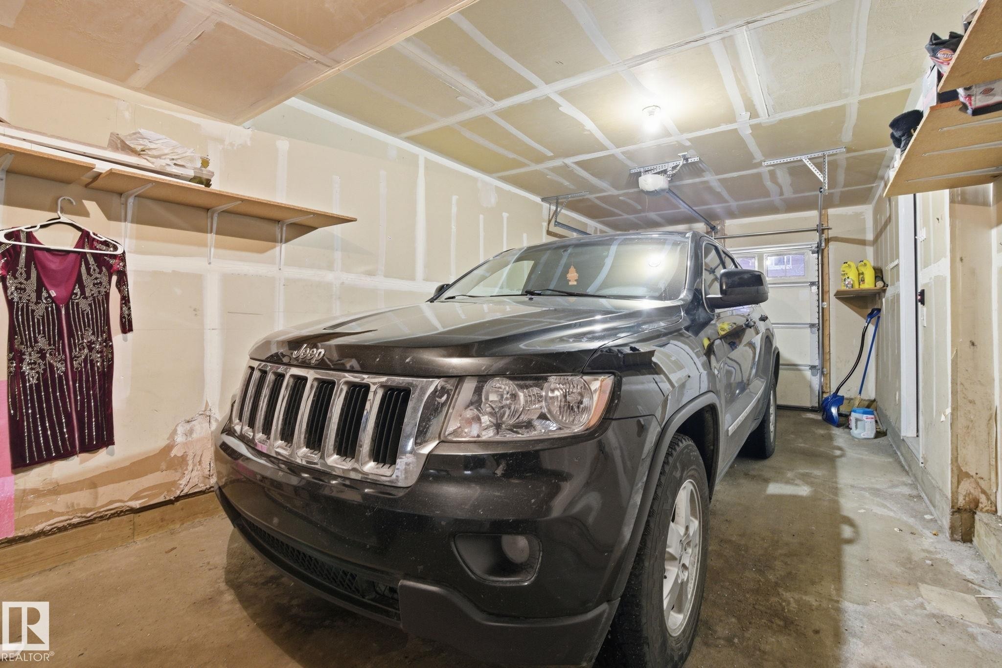 This garage features exposed stud walls and a concrete floor - 75 603 Watt Boulevard, Edmonton, AB - Indoor Photo Showing Garage