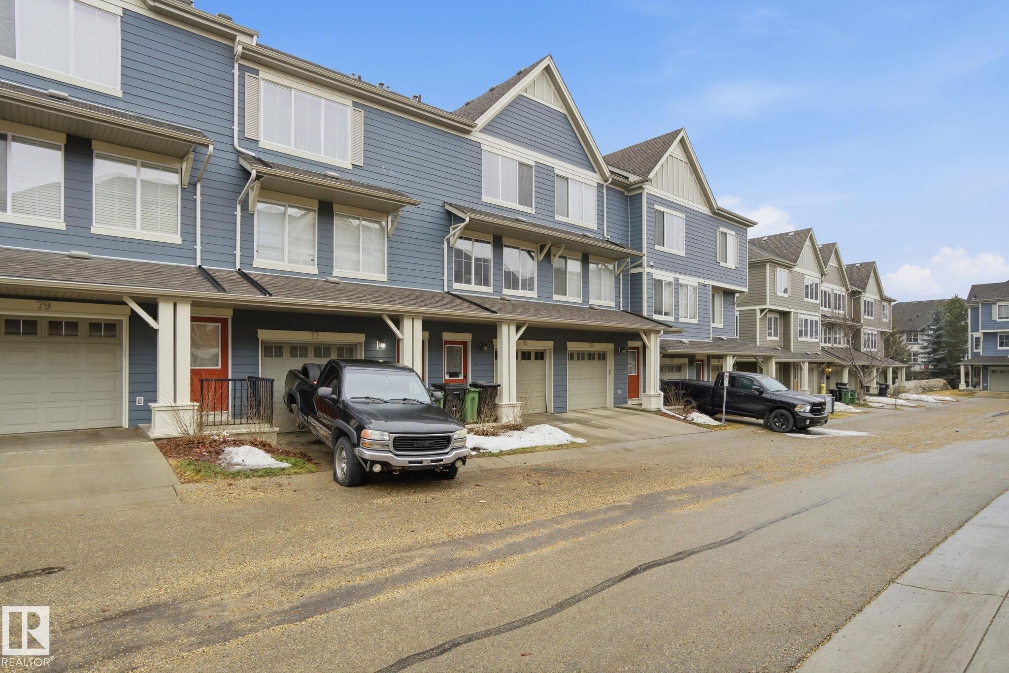 This property features a multi-story exterior with blue siding and white trim - 75 603 Watt Boulevard, Edmonton, AB - Outdoor With Facade