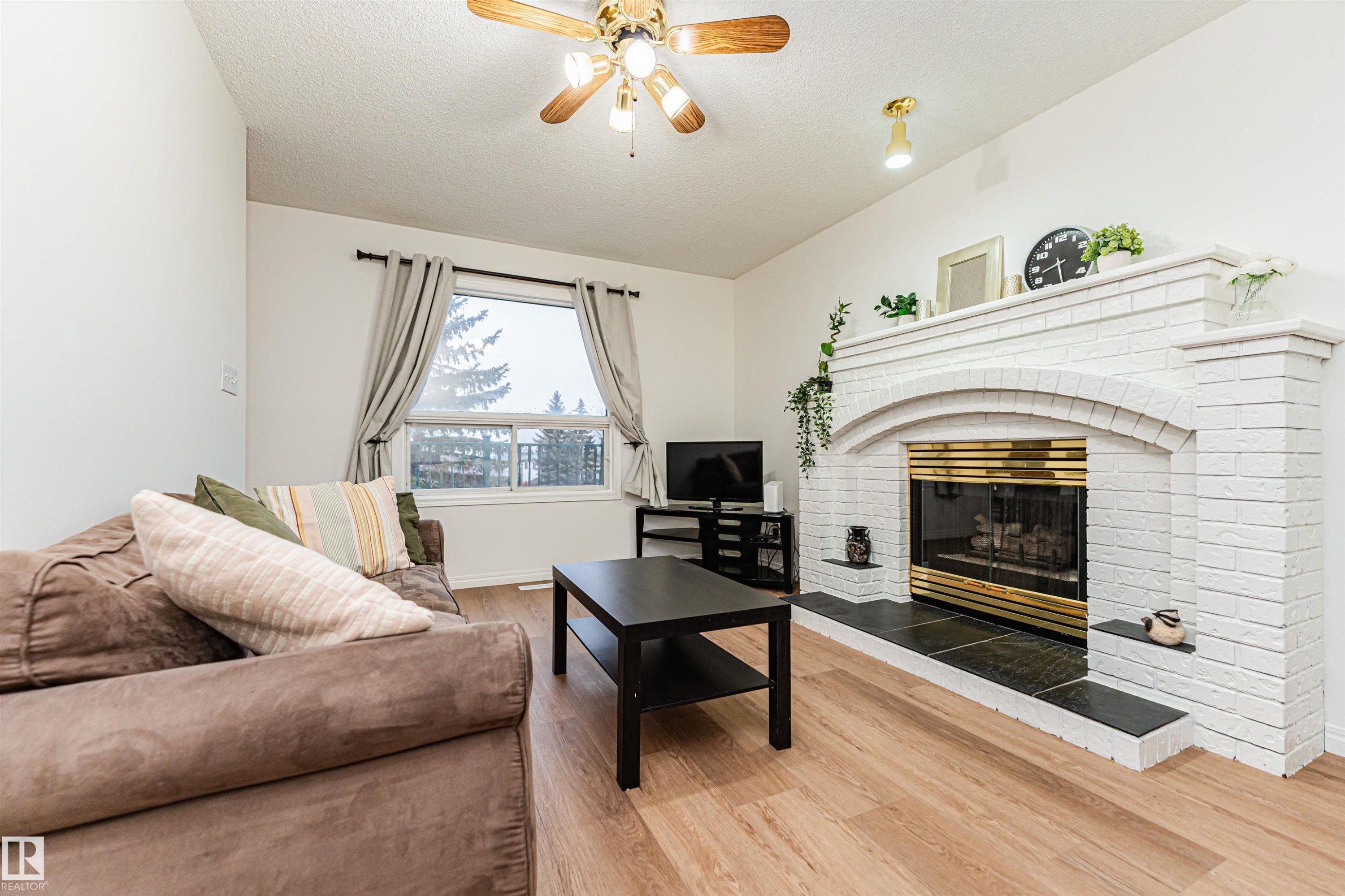 4424 33 Street, Edmonton, AB - Indoor Photo Showing Living Room With Fireplace