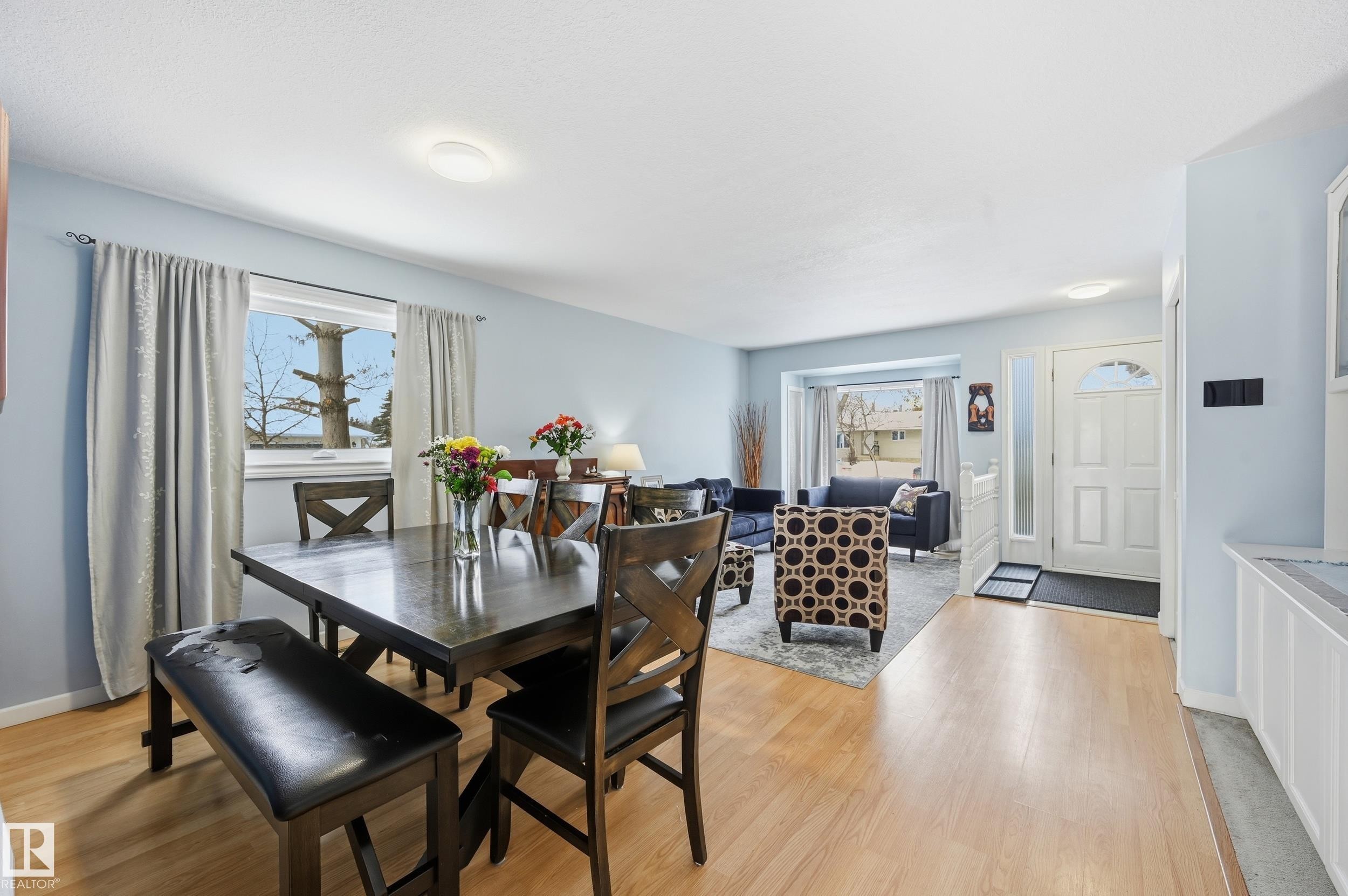 The property features an open living and dining area with light-toned flooring throughout - 85 Arlington Drive, St. Albert, AB - Indoor Photo Showing Dining Room