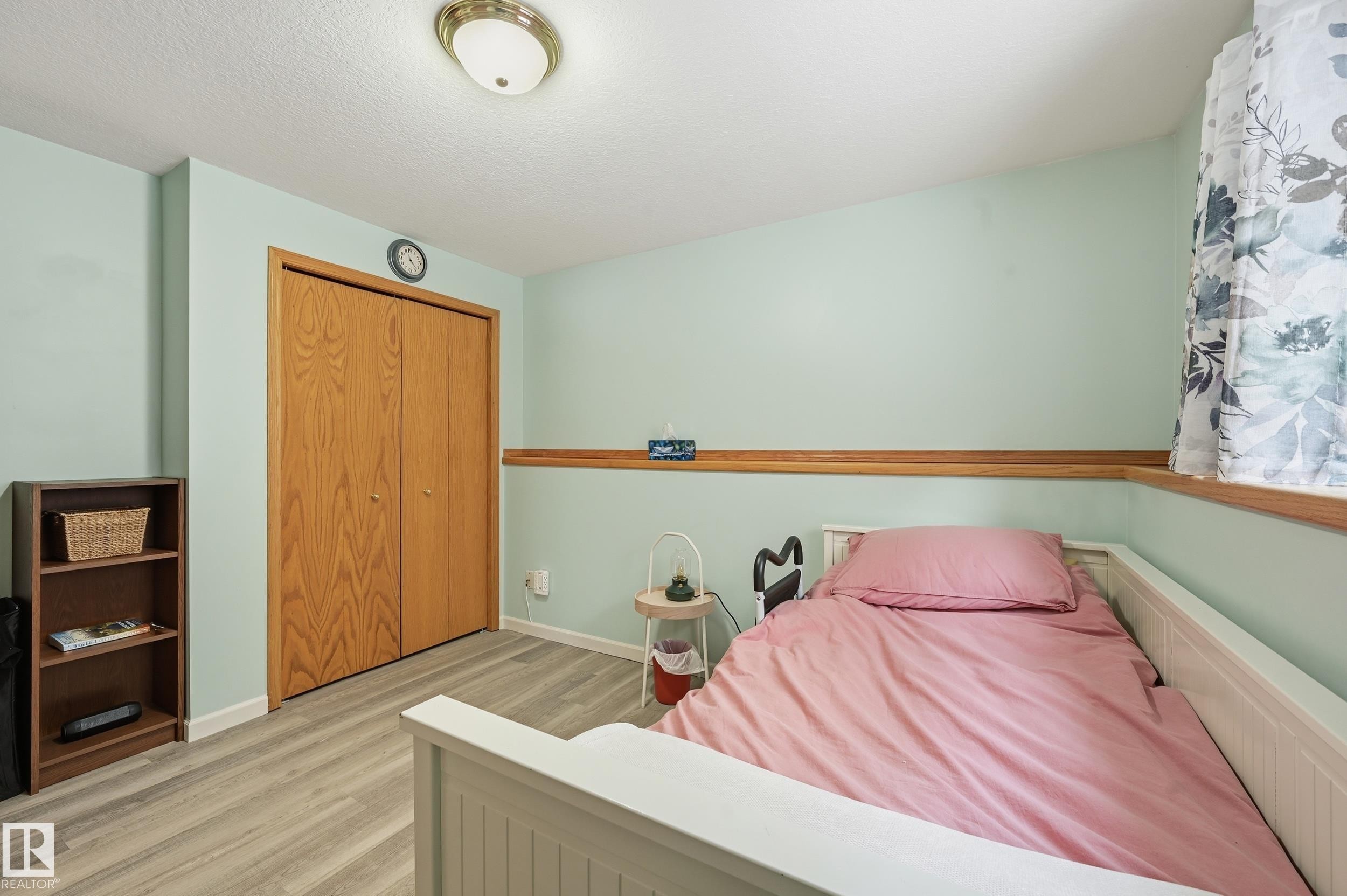 This room features light-colored walls and wood-toned flooring - 85 Arlington Drive, St. Albert, AB - Indoor Photo Showing Bedroom