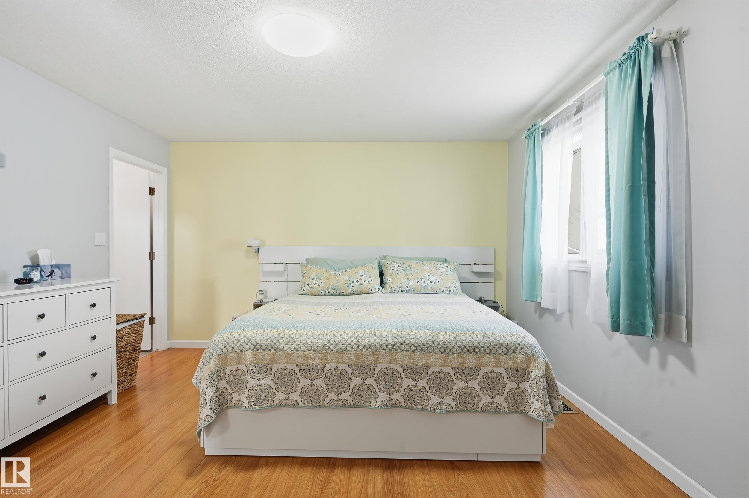 This room features wood flooring, light-toned walls, and a window providing natural light - 85 Arlington Drive, St. Albert, AB - Indoor Photo Showing Bedroom