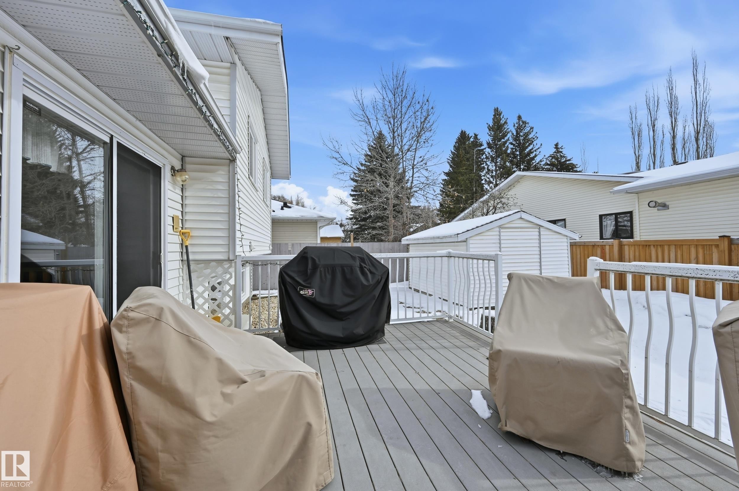 The property features a spacious outdoor deck with white railings, accessible via a sliding glass door - 85 Arlington Drive, St. Albert, AB - Outdoor With Deck Patio Veranda With Exterior
