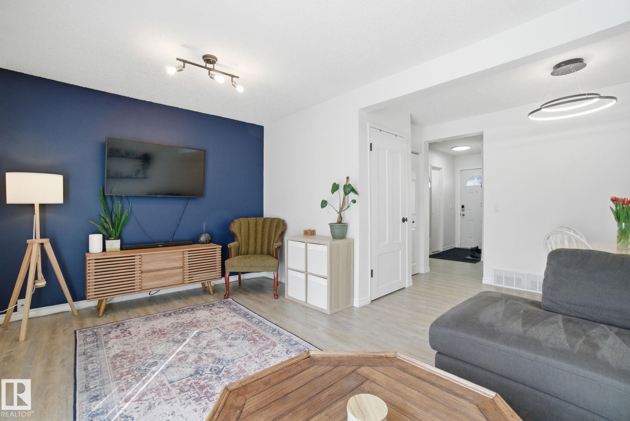 The property features light-colored flooring throughout, complemented by white walls and a striking accent wall - 29 9619 180 Street, Edmonton, AB - Indoor