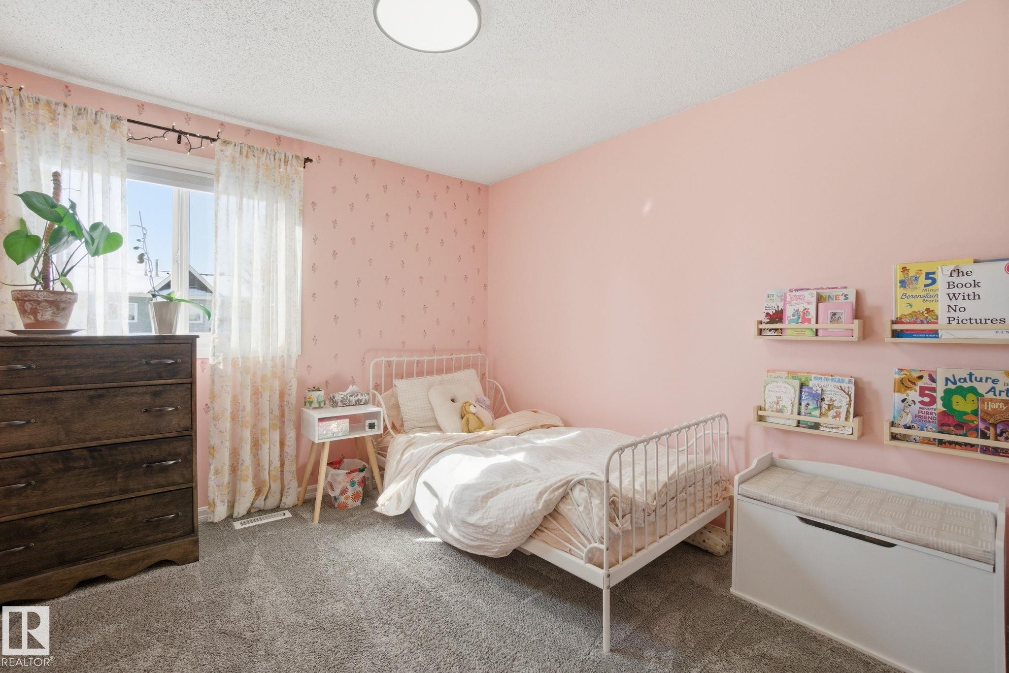 This room features soft pink walls, a window with sheer curtains, and gray carpeting - 29 9619 180 Street, Edmonton, AB - Indoor Photo Showing Bedroom