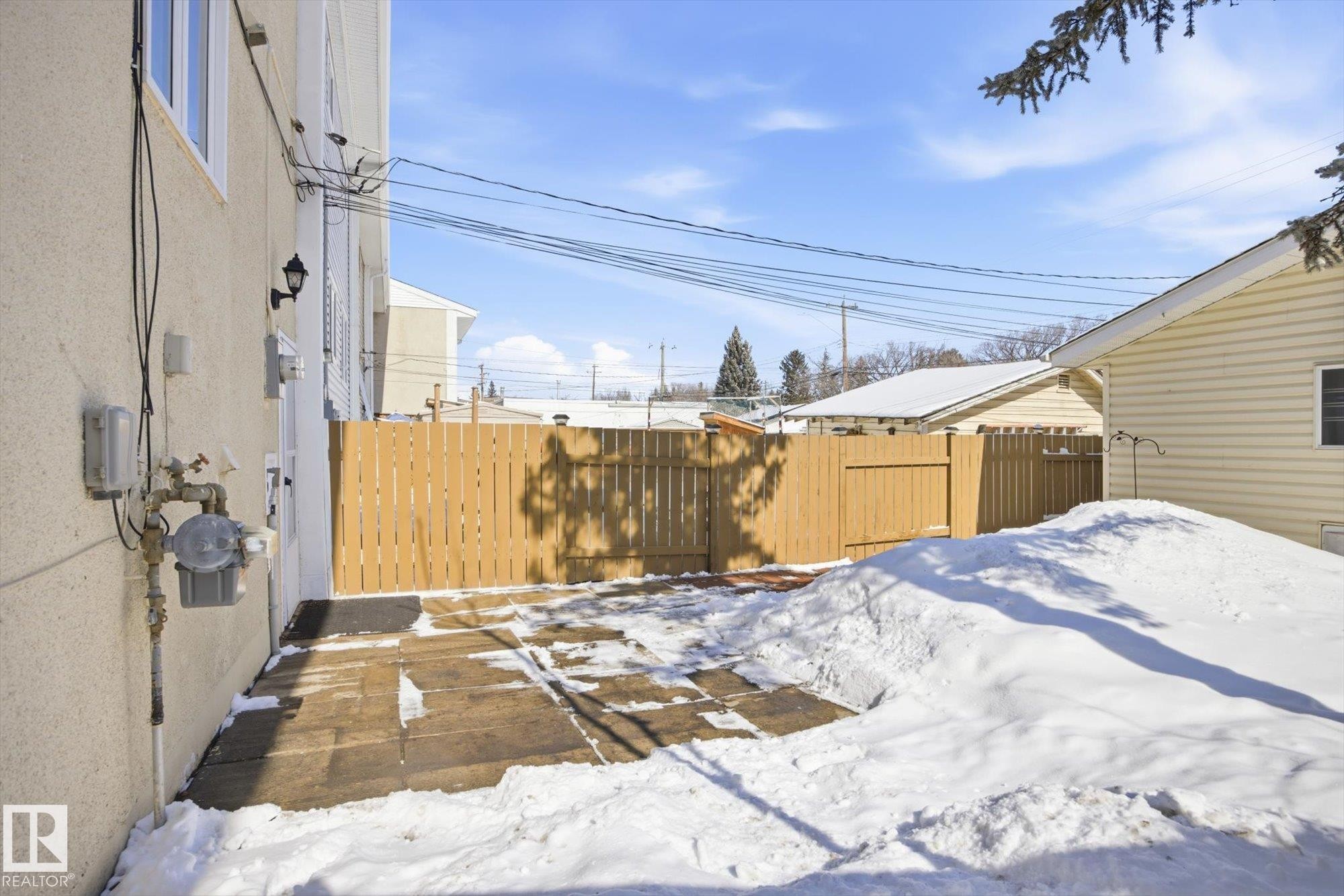 The property features a private fenced yard with a concrete patio area, ideal for outdoor enjoyment - 6 Garden Crescent, St. Albert, AB - Outdoor