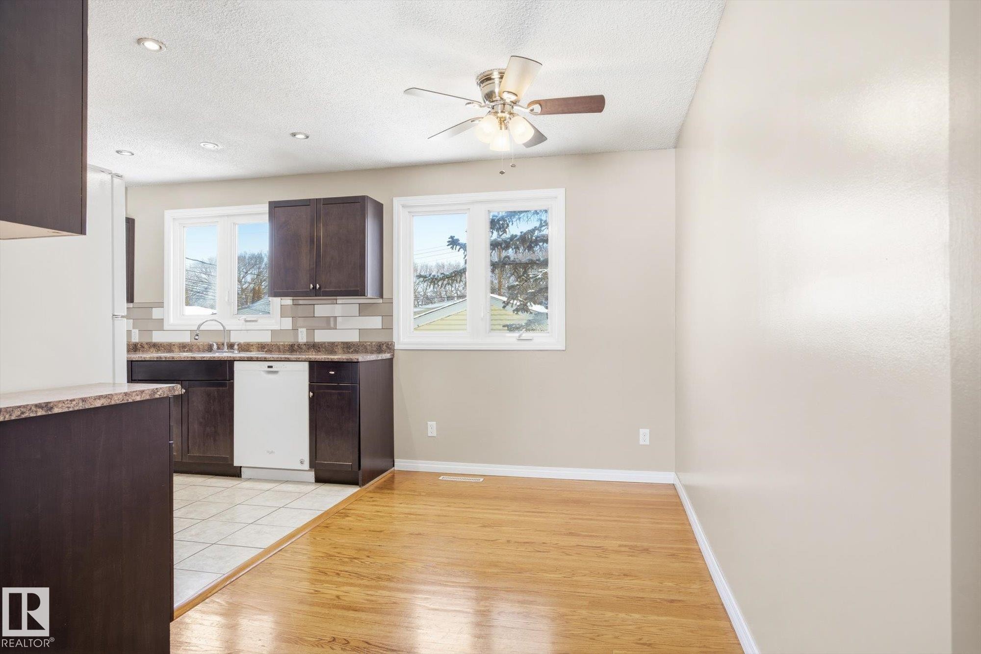 This bright space features hardwood flooring and recessed lighting, complemented by a ceiling fan - 6 Garden Crescent, St. Albert, AB - Indoor