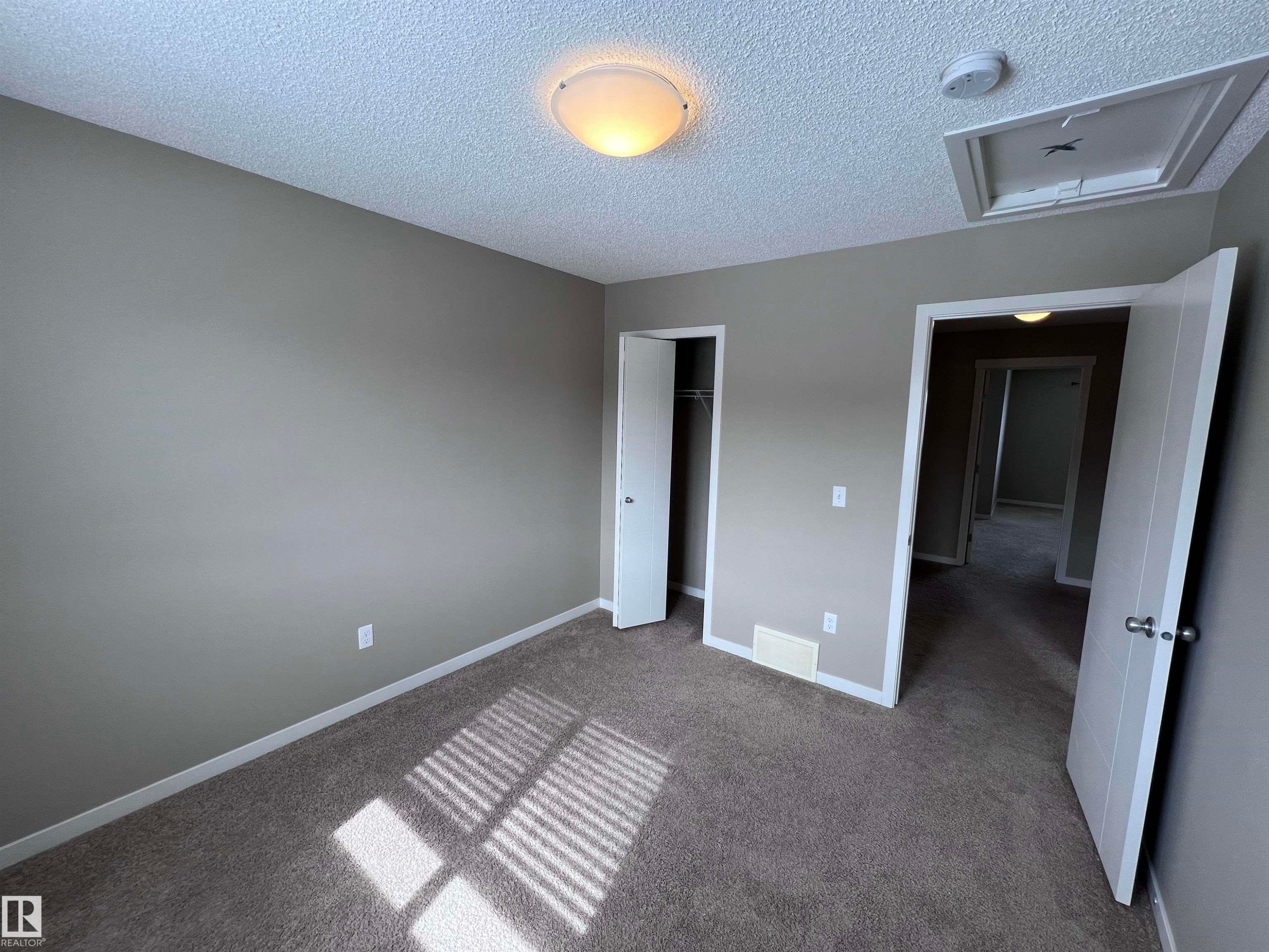 Room with textured ceiling, a flush mount light fixture, and a window with blinds - 1421 26 Avenue, Edmonton, AB - Indoor Photo Showing Other Room
