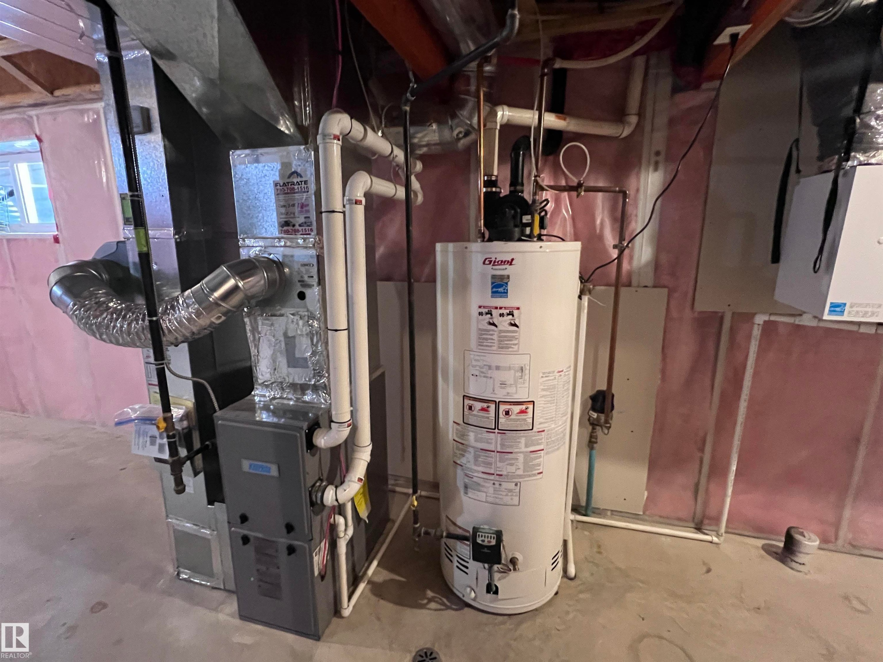 The property features an unfinished lower level with exposed ceiling joists, concrete flooring, and exposed ductwork - 1421 26 Avenue, Edmonton, AB - Indoor Photo Showing Basement