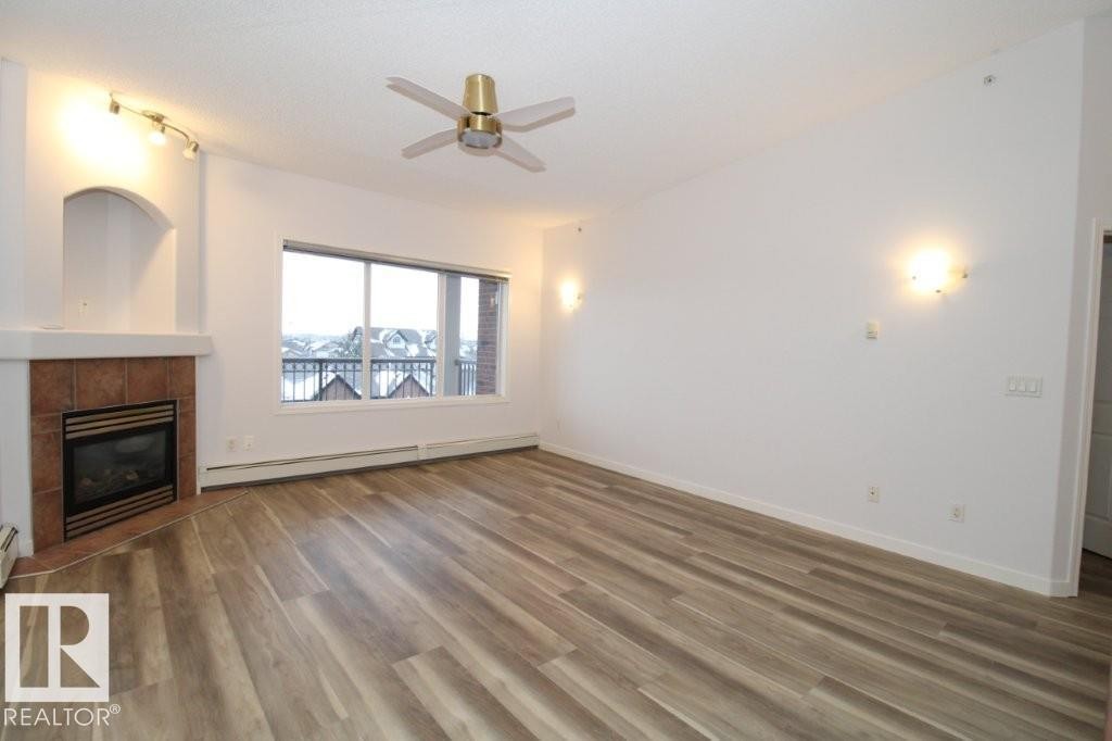 414 5280 Terwillegar Boulevard, Edmonton, AB - Indoor Photo Showing Living Room With Fireplace