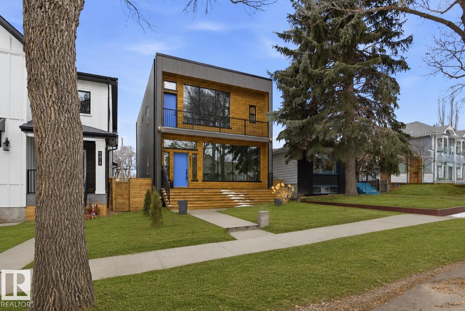 Modern architectural design featuring prominent wood-finish siding, dark paneling, and large windows - 9821 85 Avenue, Edmonton, AB - Outdoor