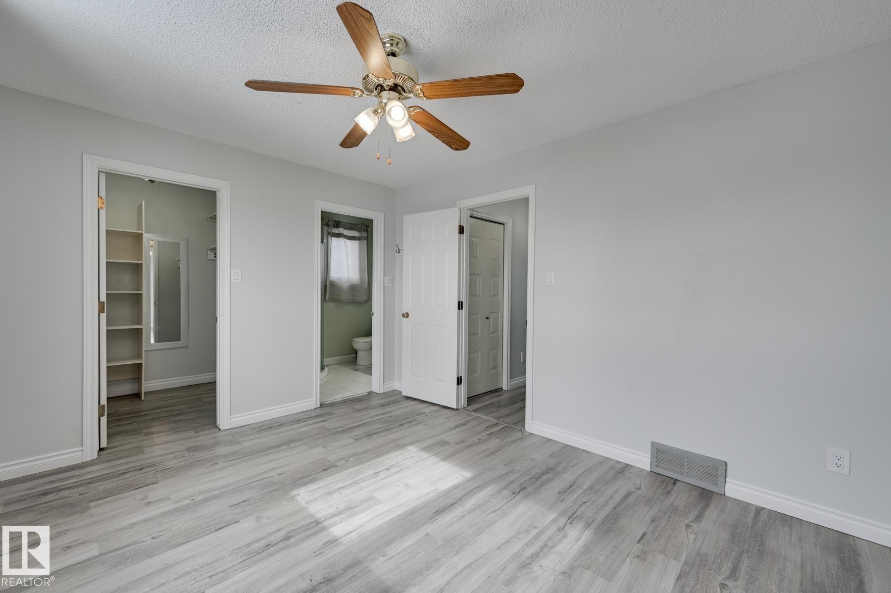 This room features light-colored walls and wood-style flooring - 8507 152B Avenue, Edmonton, AB - Indoor Photo Showing Other Room