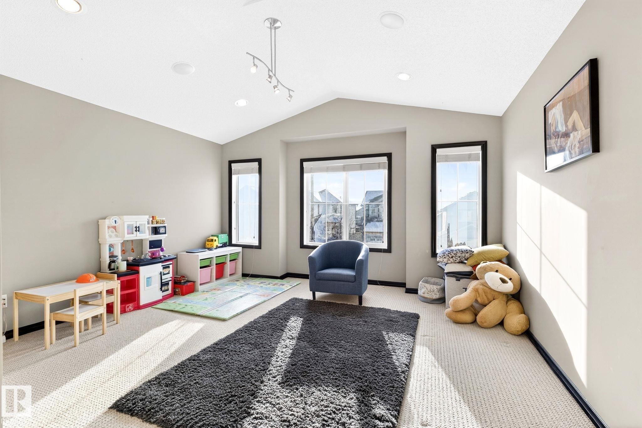 This room features a vaulted ceiling with recessed lighting and a track light fixture - 1121 59A Street, Edmonton, AB - Indoor Photo Showing Other Room