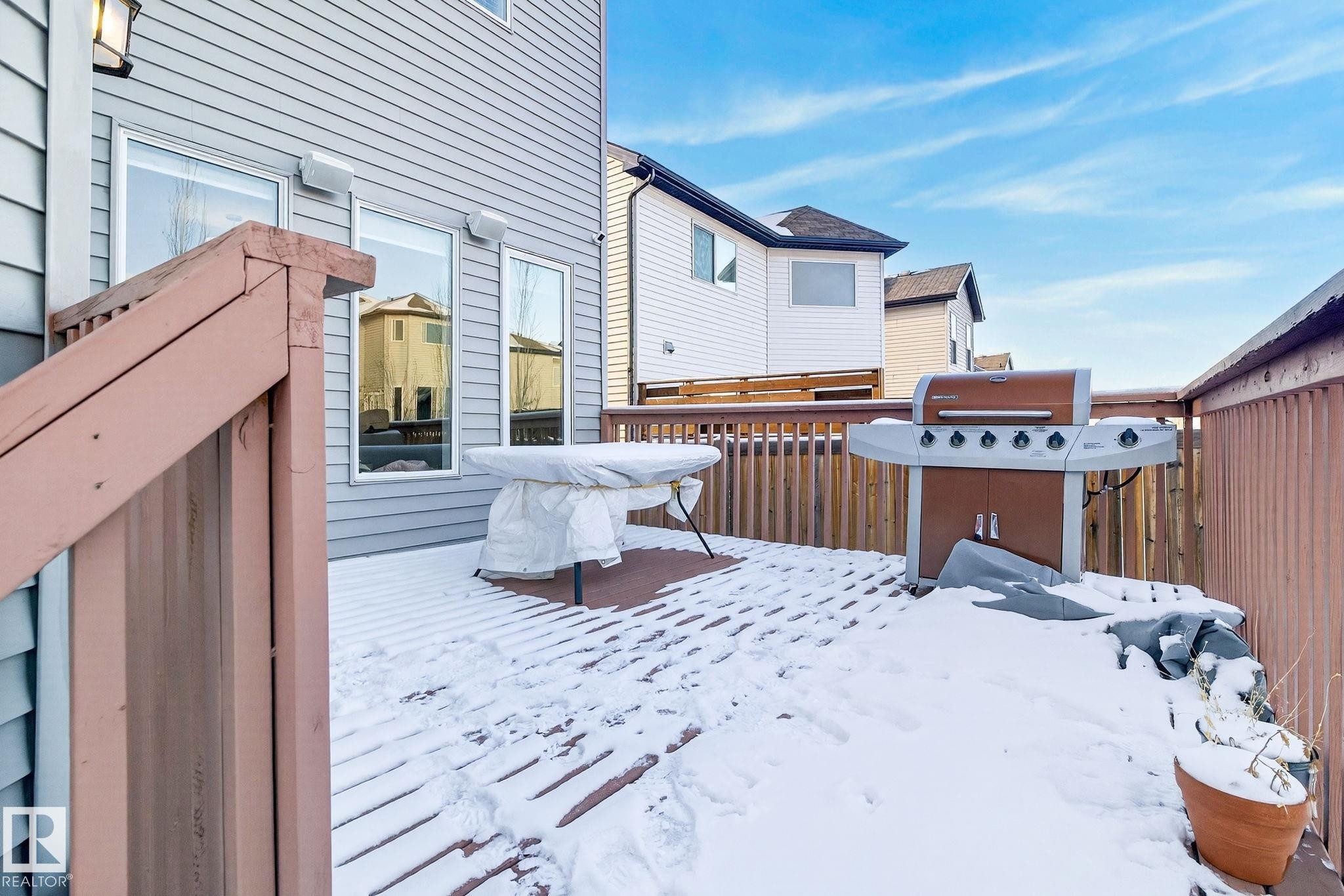 The property features a spacious outdoor deck with wood railings - 1121 59A Street, Edmonton, AB - Outdoor With Deck Patio Veranda With Exterior
