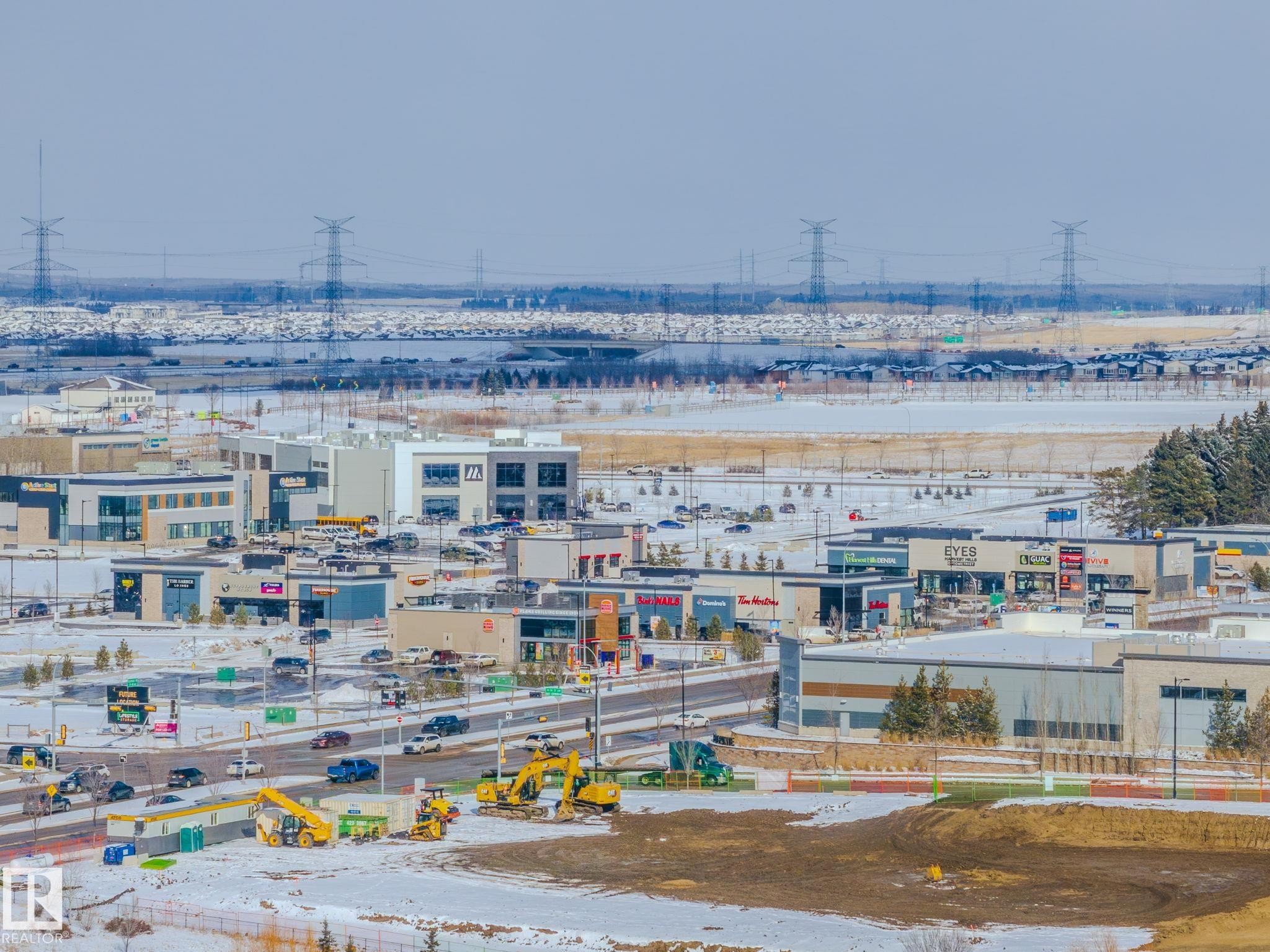 View of the community, featuring commercial buildings, roads, and a large undeveloped area - 1121 59A Street, Edmonton, AB - Outdoor With View