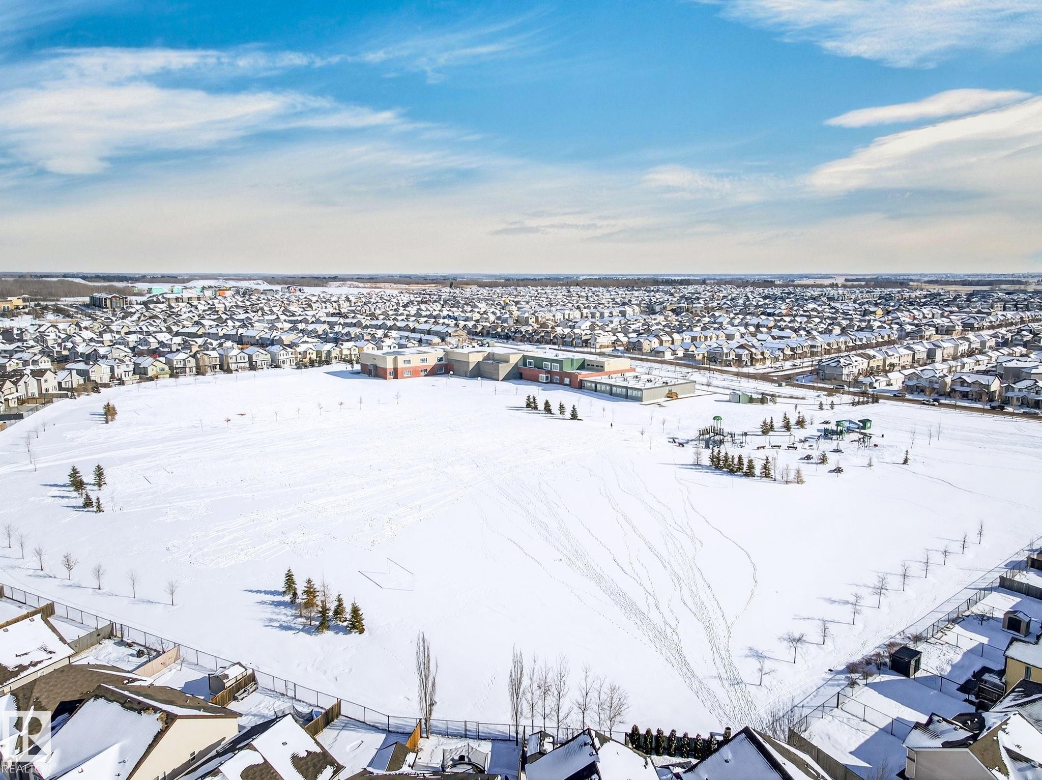 Aerial view showcasing the expansive snow-covered field and surrounding residential properties - 1121 59A Street, Edmonton, AB - Outdoor With View