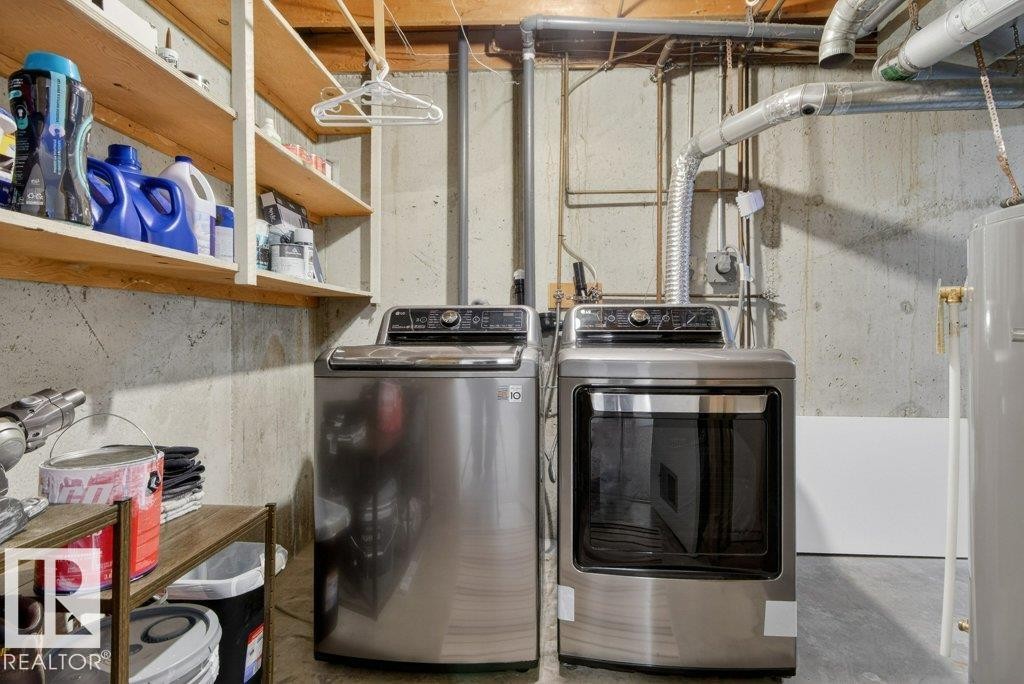 Laundry area featuring a top-loading washing machine and a front-loading dryer, alongside exposed ductwork and open shelving - 91 Hearthstone, Edmonton, AB - Indoor