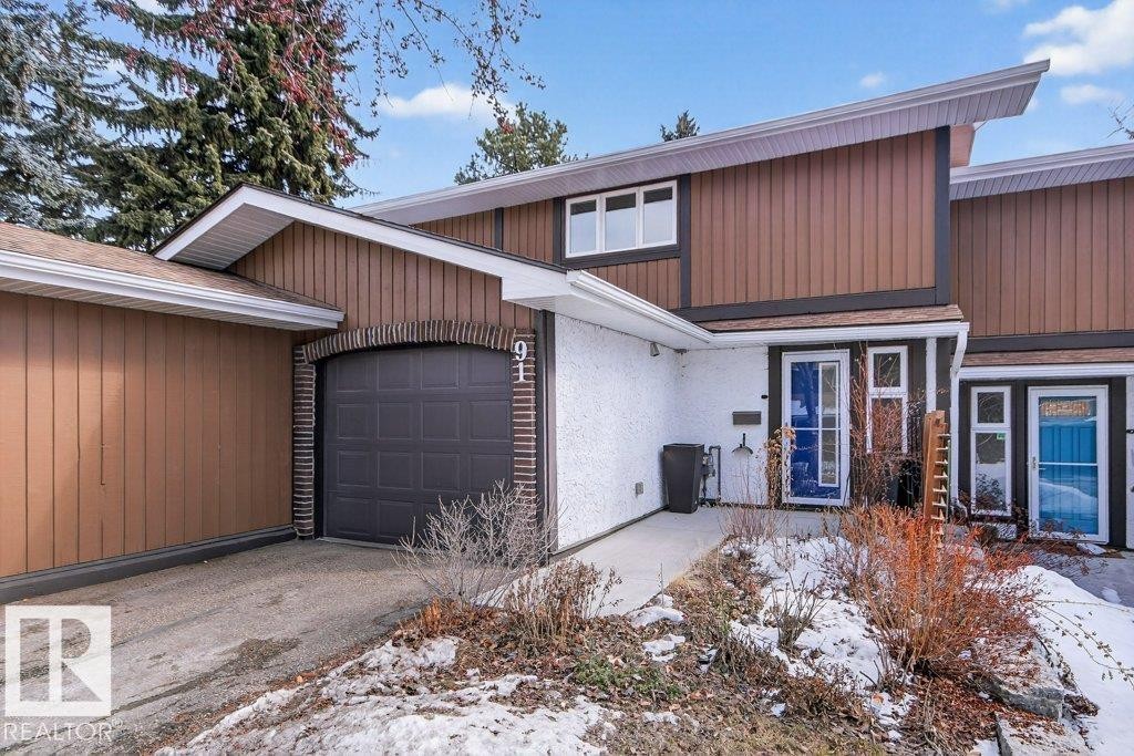 The property features cedar and stucco exterior with a single attached garage - 91 Hearthstone, Edmonton, AB - Outdoor