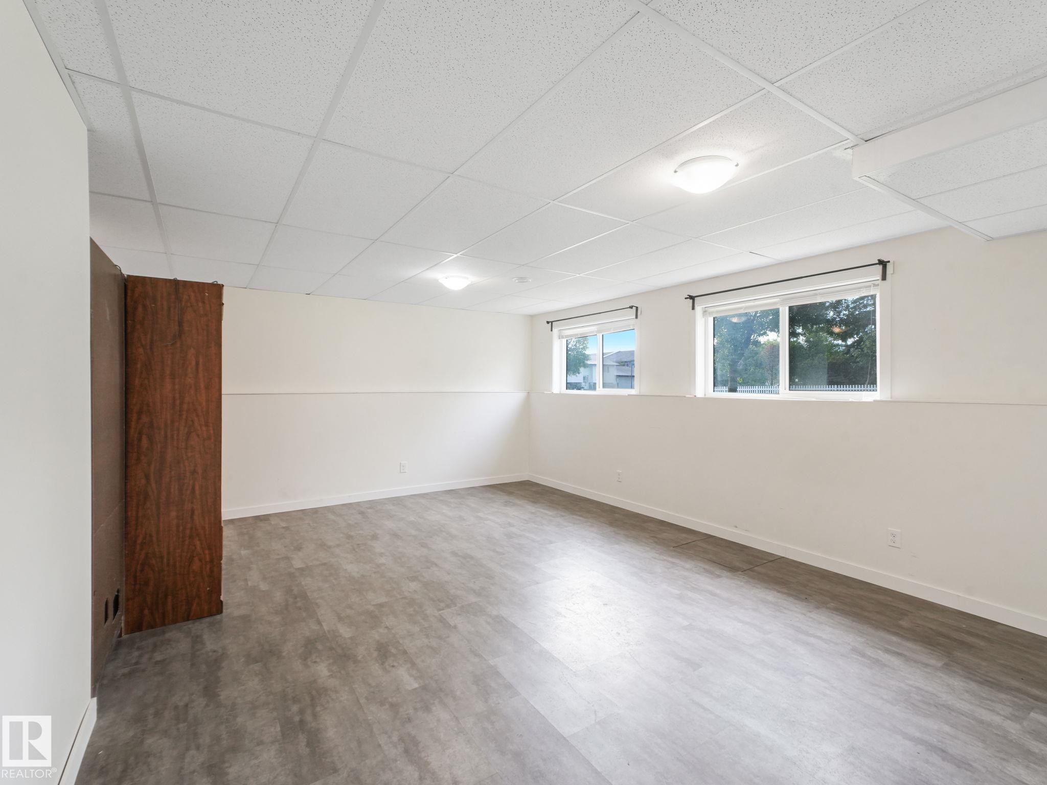 Spacious room featuring light-colored walls, recessed lighting, and two windows providing natural light - 5035 51 Avenue, Lamont, AB - Indoor Photo Showing Other Room