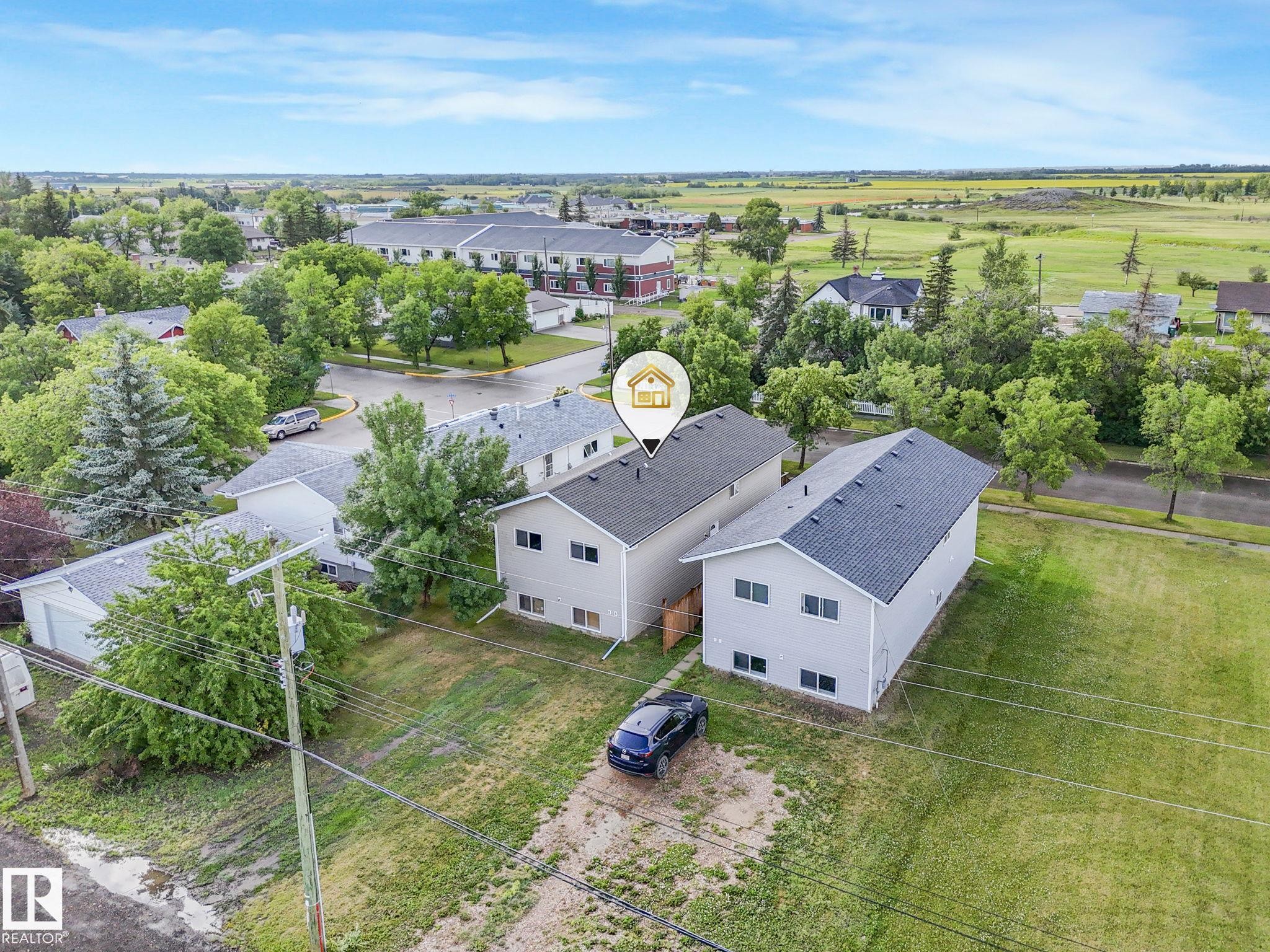 Two-story duplex featuring light gray siding and dark shingle roofing - 5035 51 Avenue, Lamont, AB - Outdoor With View