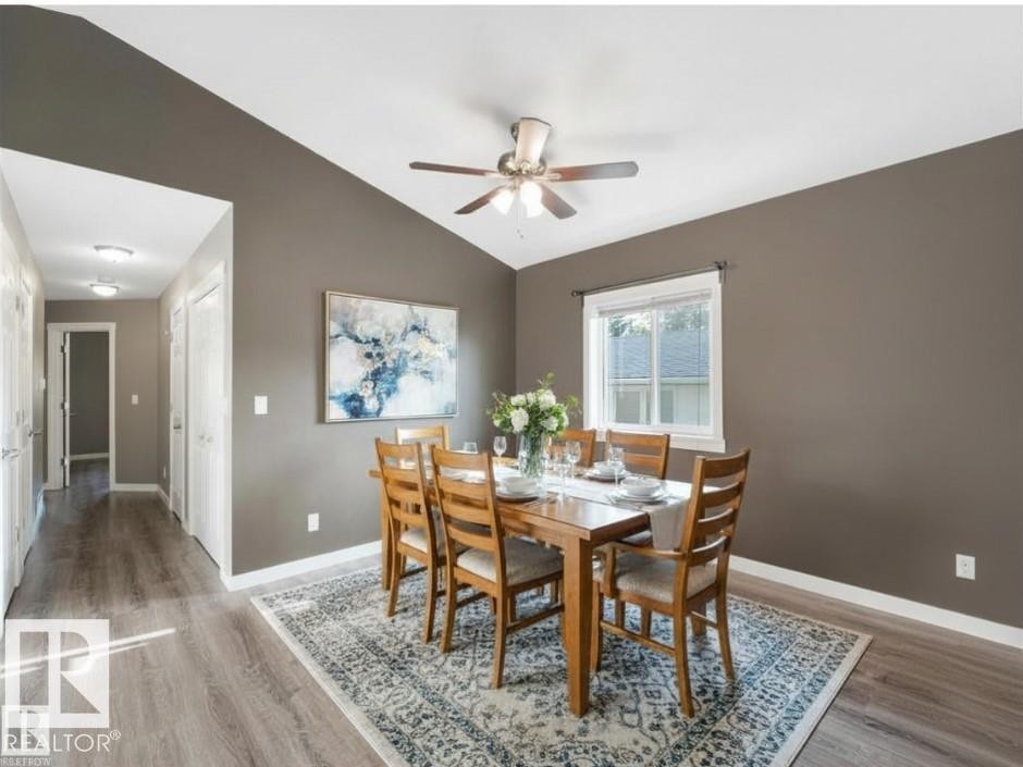 Dining area featuring vaulted ceilings, a window with exterior views, and a ceiling fan - 5035 51 Avenue, Lamont, AB - Indoor Photo Showing Dining Room
