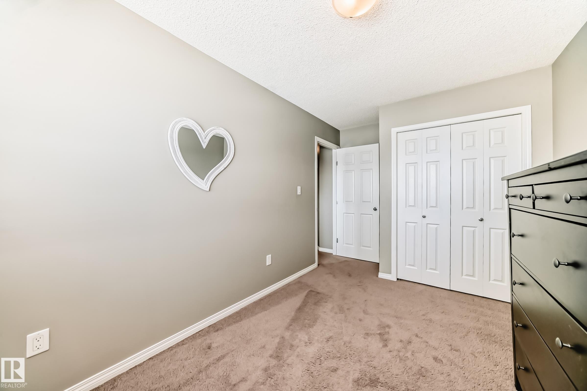 This room features neutral-toned carpeting, light gray walls, and white trim - 86 4029 Orchards Drive, Edmonton, AB - Indoor Photo Showing Other Room