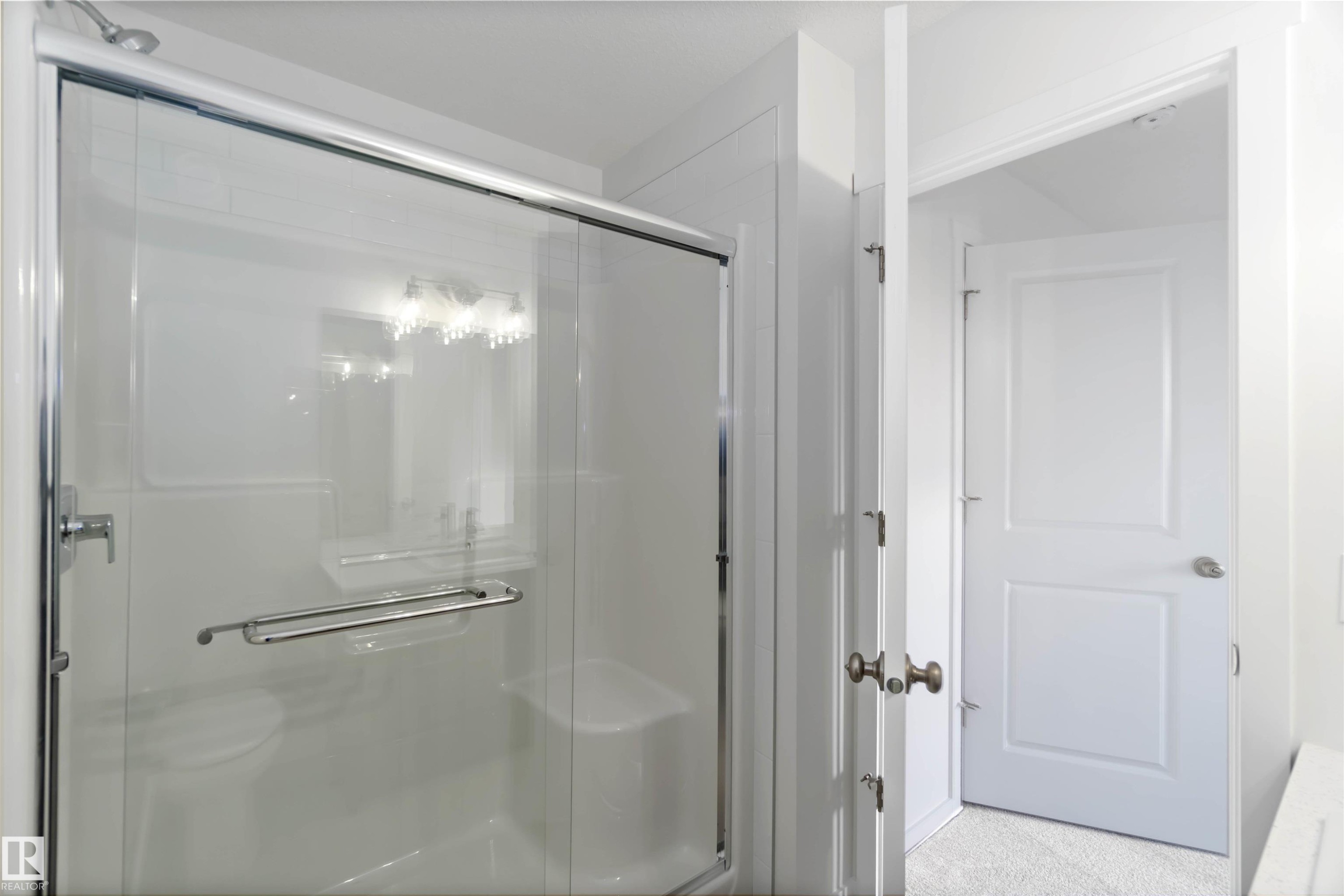 Bathroom featuring a clear glass shower enclosure with chrome hardware and a white interior - 5452 Hawthorn Run, Edmonton, AB - Indoor Photo Showing Bathroom