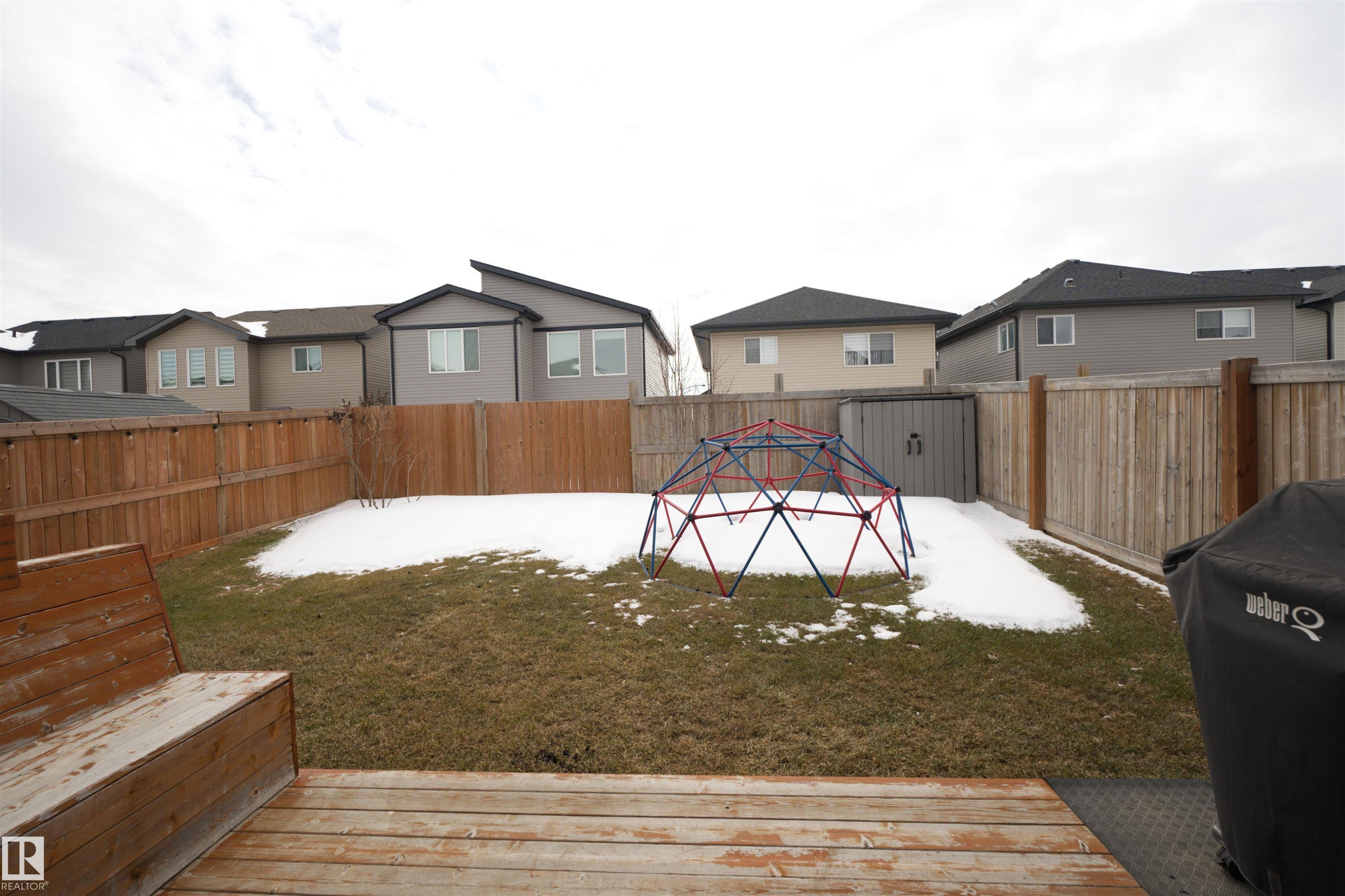The property features a fenced yard with a combination of grass and snow cover - 20503 99 Avenue, Edmonton, AB - Outdoor With Exterior