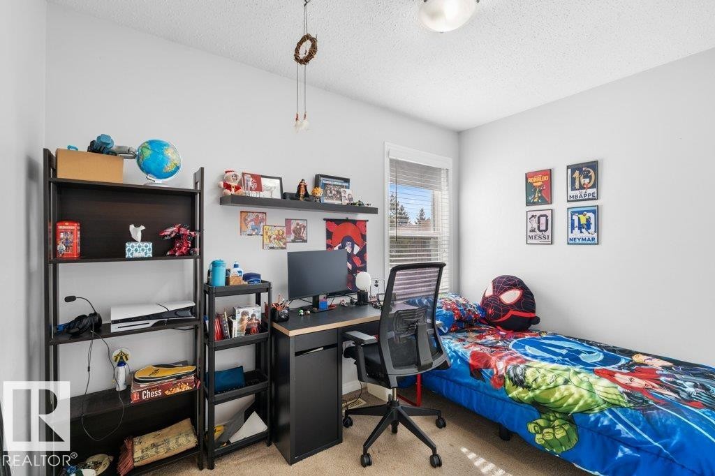 This room features light-colored walls and carpet flooring, creating a bright and neutral base - 638 Saddleback Road, Edmonton, AB - Indoor Photo Showing Bedroom