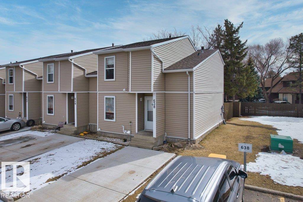 This property features a beige siding exterior with white trim and a shingled roof - 638 Saddleback Road, Edmonton, AB - Outdoor