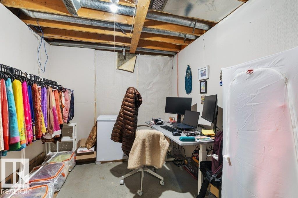 This room features exposed ceiling joists and ductwork, providing a raw aesthetic - 638 Saddleback Road, Edmonton, AB - Indoor