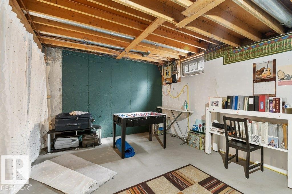 The property features an unfinished basement with exposed wooden beams, concrete flooring, and a window - 638 Saddleback Road, Edmonton, AB - Indoor Photo Showing Basement