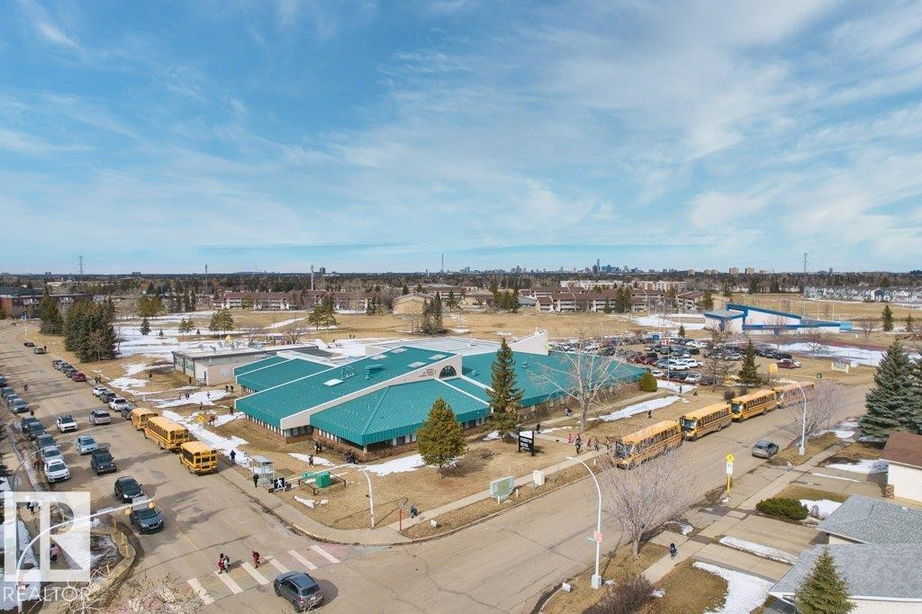 Aerial view of the neighborhood, showcasing residential properties and a nearby institution with a teal roof - 638 Saddleback Road, Edmonton, AB - Outdoor With View
