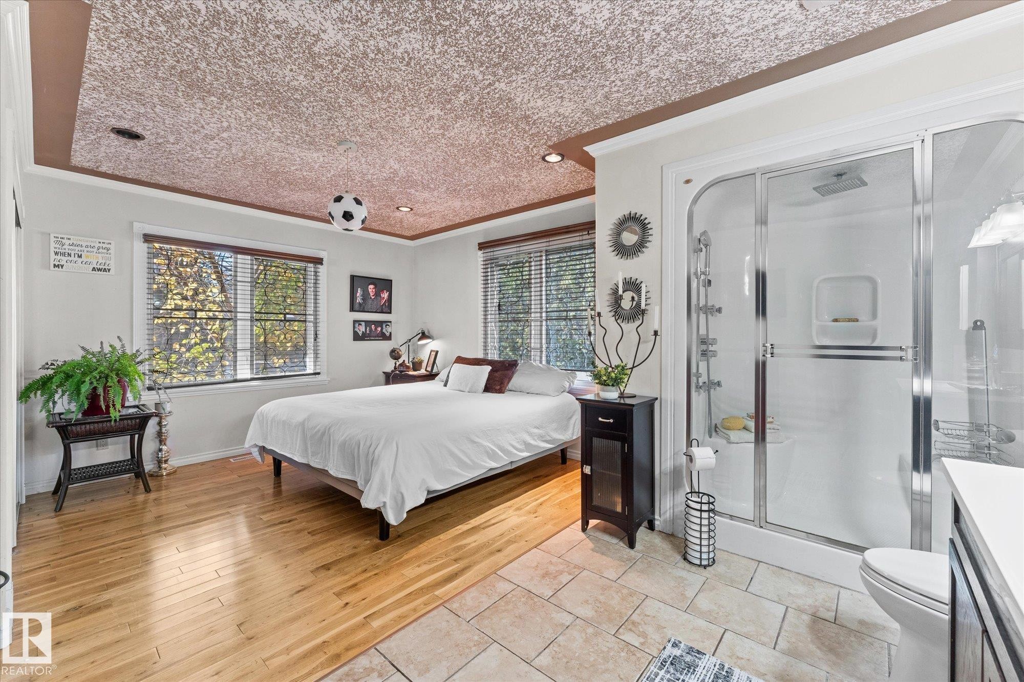 Bedroom featuring light wood flooring, large windows, and a tiled ceiling with recessed lighting - 11124 110A Avenue, Edmonton, AB - Indoor Photo Showing Bedroom