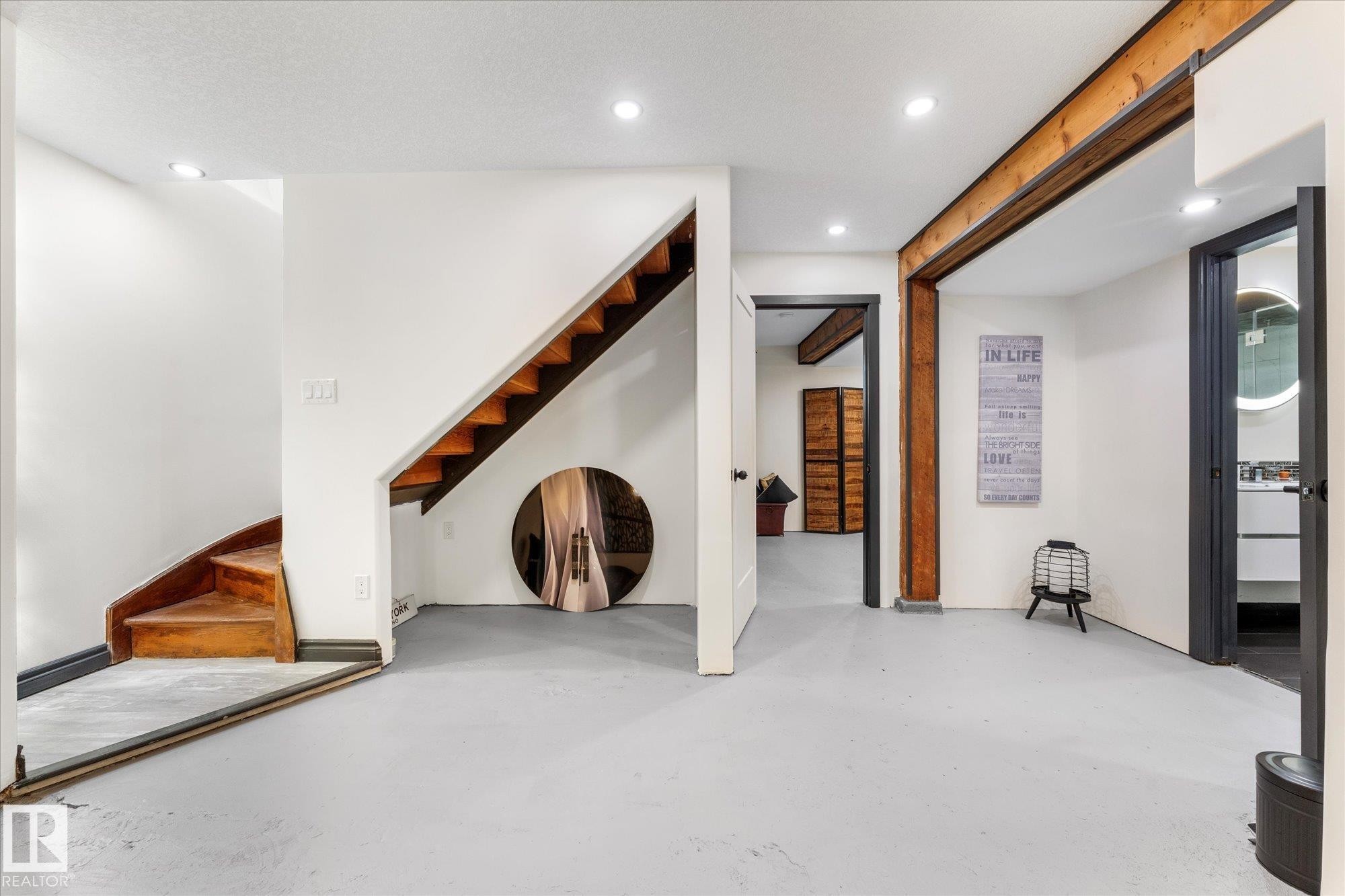 Finished space with light-colored flooring, recessed lighting, and a visible staircase with wooden treads - 11124 110A Avenue, Edmonton, AB - Indoor