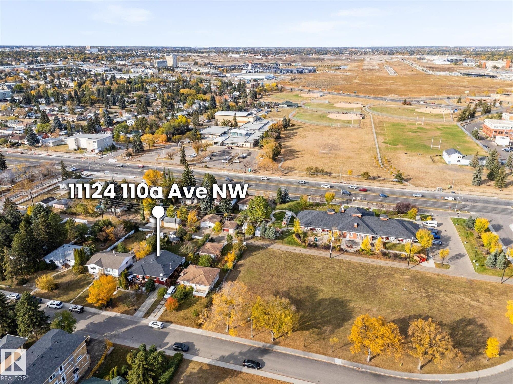 Aerial view showcasing the property situated within a developed neighborhood with mature trees - 11124 110A Avenue, Edmonton, AB - Outdoor With View
