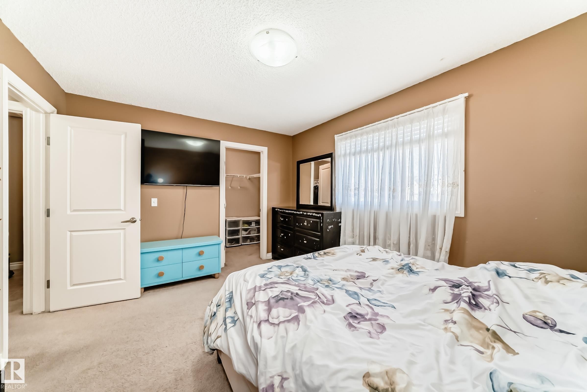 This room features carpeted flooring, a window with blinds, and doors - 23 445 Brintnell Boulevard Nw, Edmonton, AB - Indoor Photo Showing Bedroom