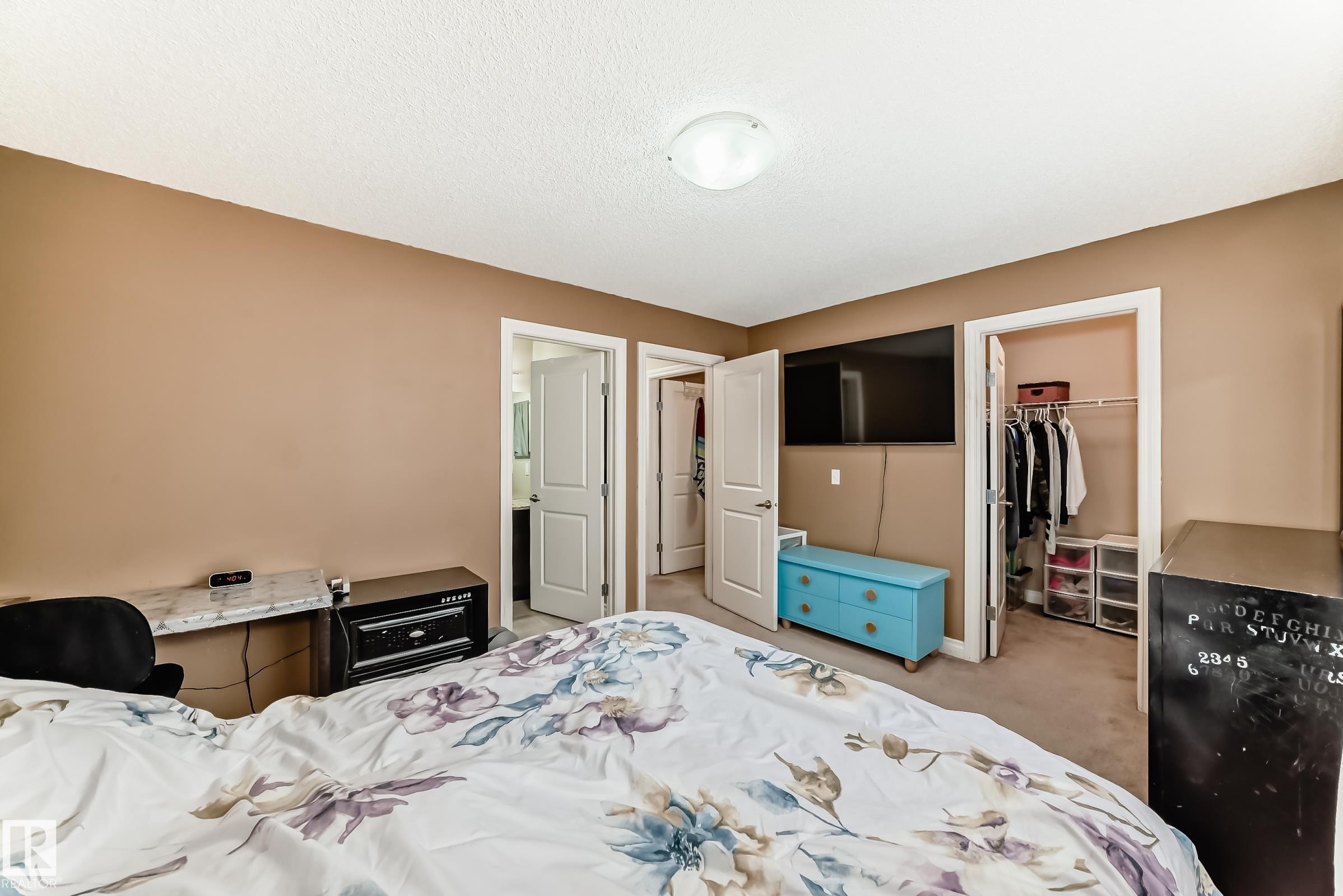 Bedroom featuring light brown walls and carpeted flooring - 23 445 Brintnell Boulevard Nw, Edmonton, AB - Indoor Photo Showing Bedroom