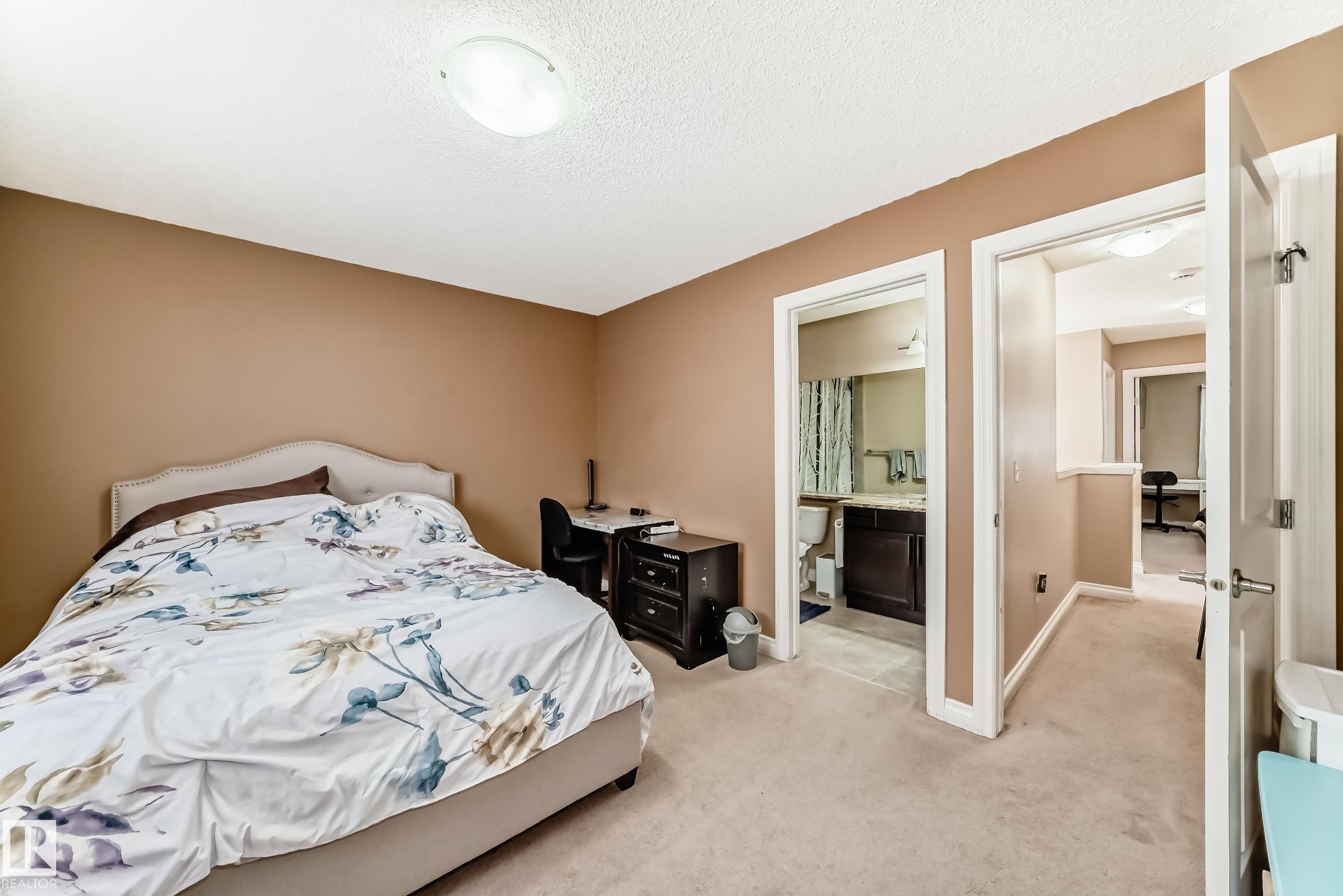 This room features neutral-toned walls and carpeted flooring - 23 445 Brintnell Boulevard Nw, Edmonton, AB - Indoor Photo Showing Bedroom