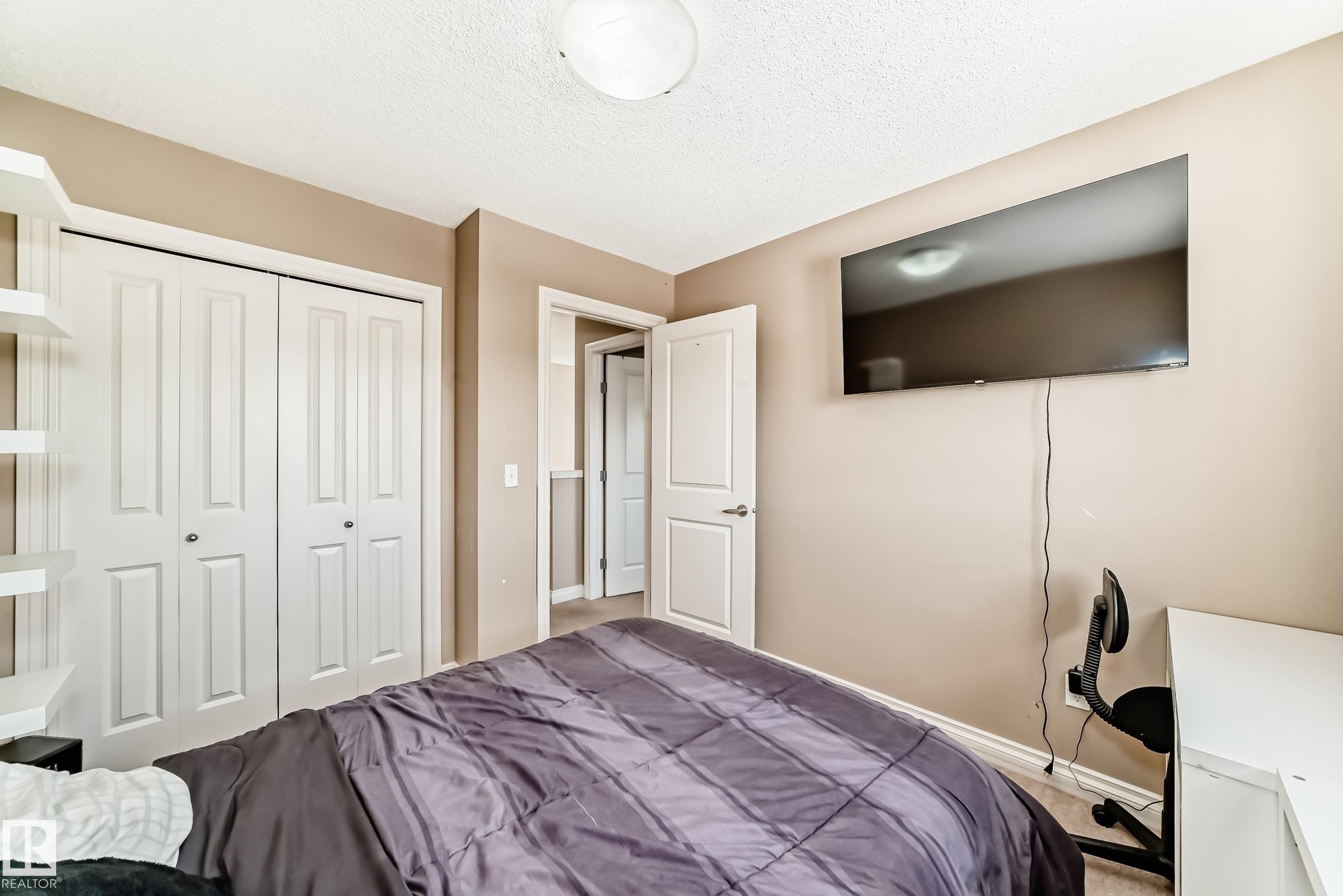 This room features light-colored walls and white trim, along with a ceiling light fixture - 23 445 Brintnell Boulevard Nw, Edmonton, AB - Indoor Photo Showing Bedroom