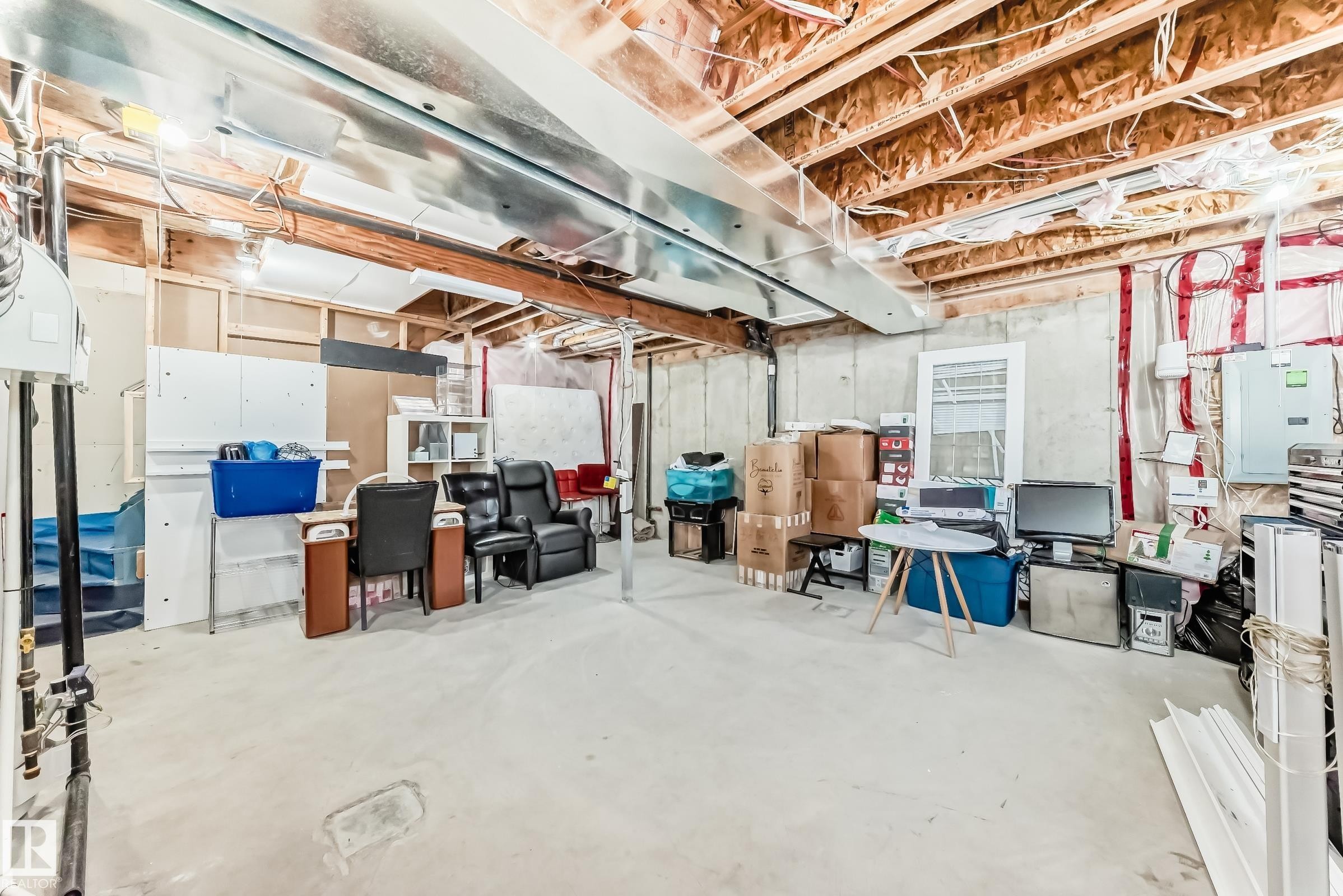 The property features an unfinished basement with a concrete floor, exposed ceiling joists, and visible ductwork - 23 445 Brintnell Boulevard Nw, Edmonton, AB - Indoor Photo Showing Basement