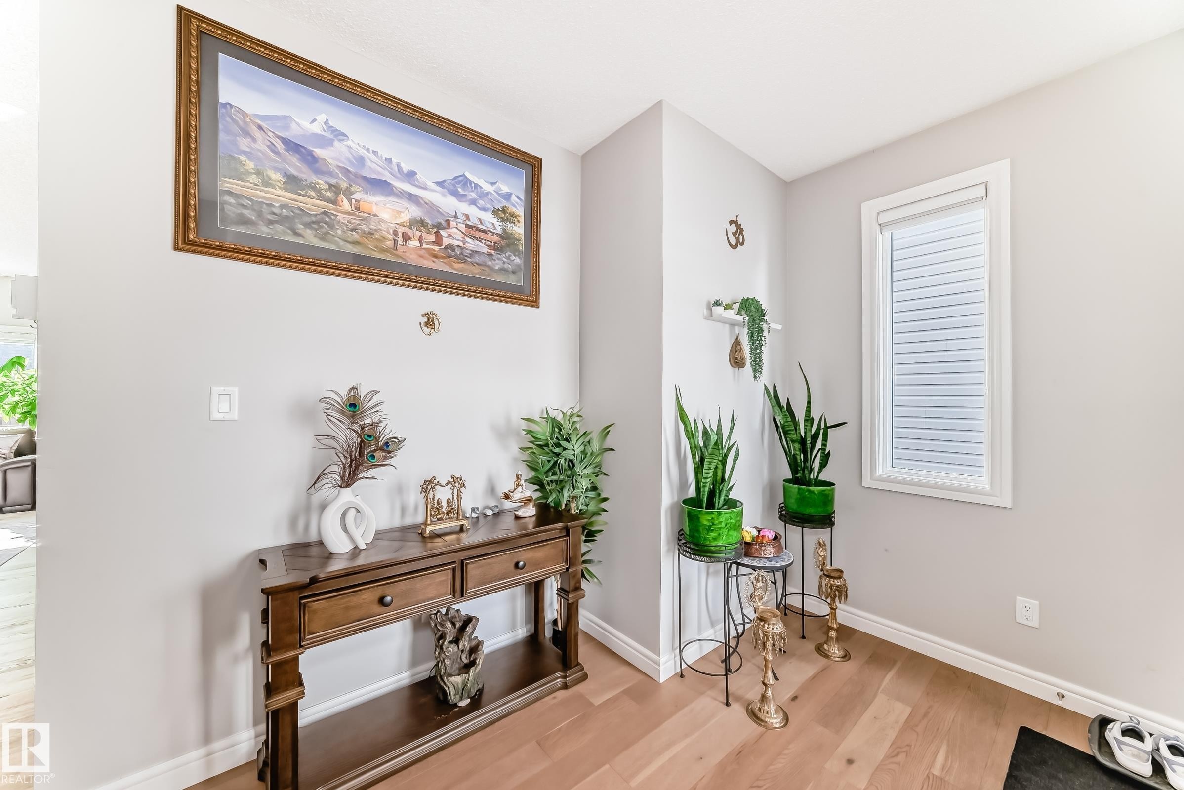 Inviting entryway featuring light wood flooring, light-colored walls, and a window with blinds - 22407 99 Avenue, Edmonton, AB - Indoor Photo Showing Other Room