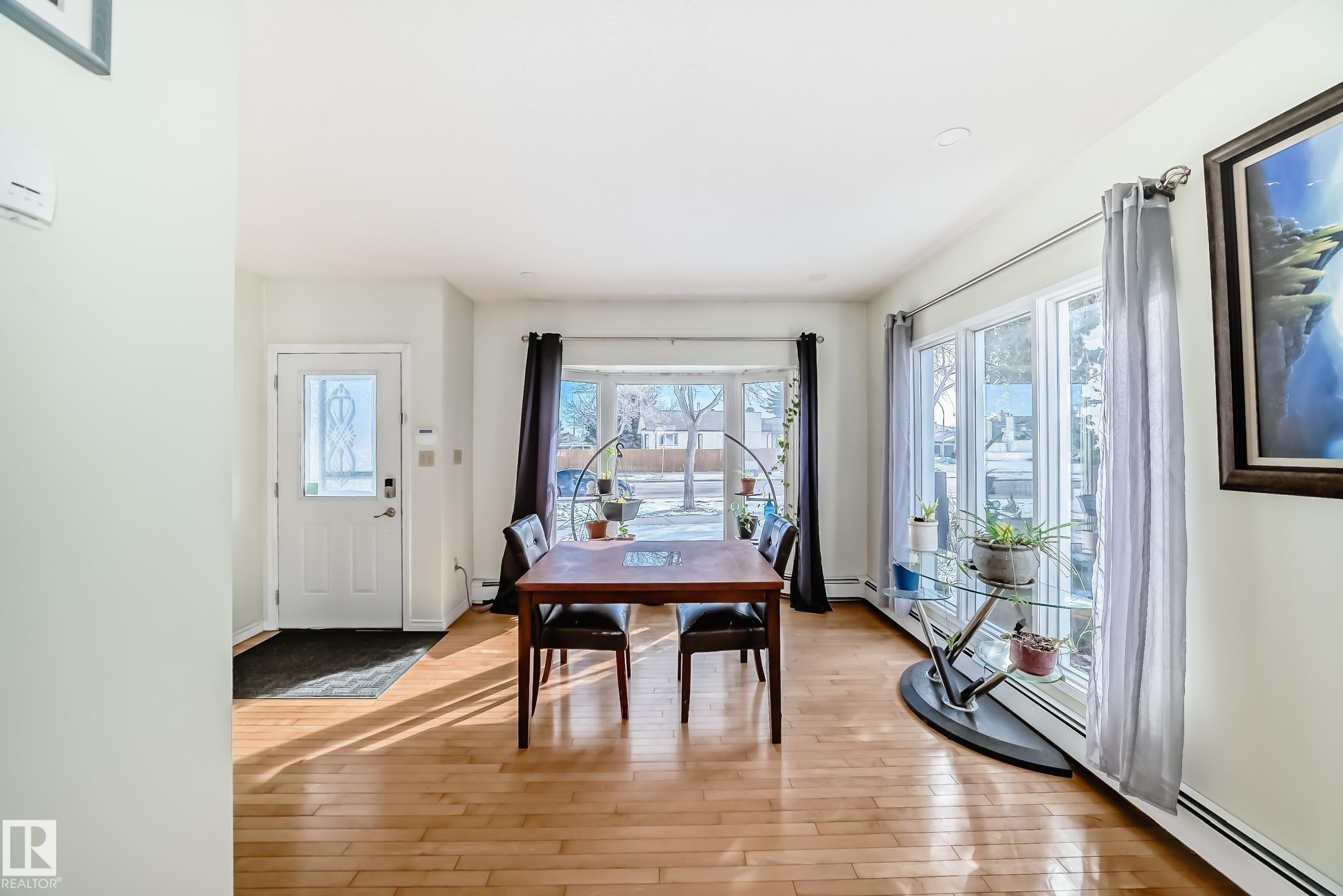 This welcoming space features hardwood flooring and large windows, providing abundant natural light - 16232 100 Street, Edmonton, AB - Indoor